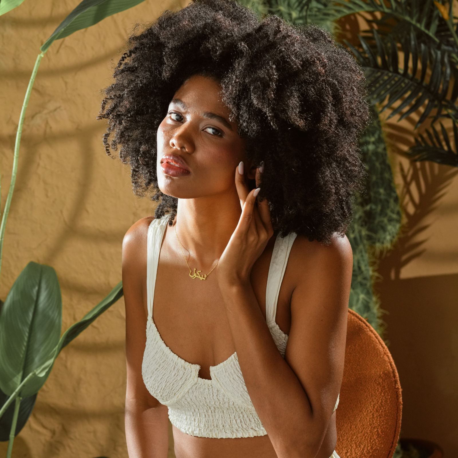 Model wearing a Personalized Arabic Name Necklace, showcasing high-quality sterling silver in a stylish setting.