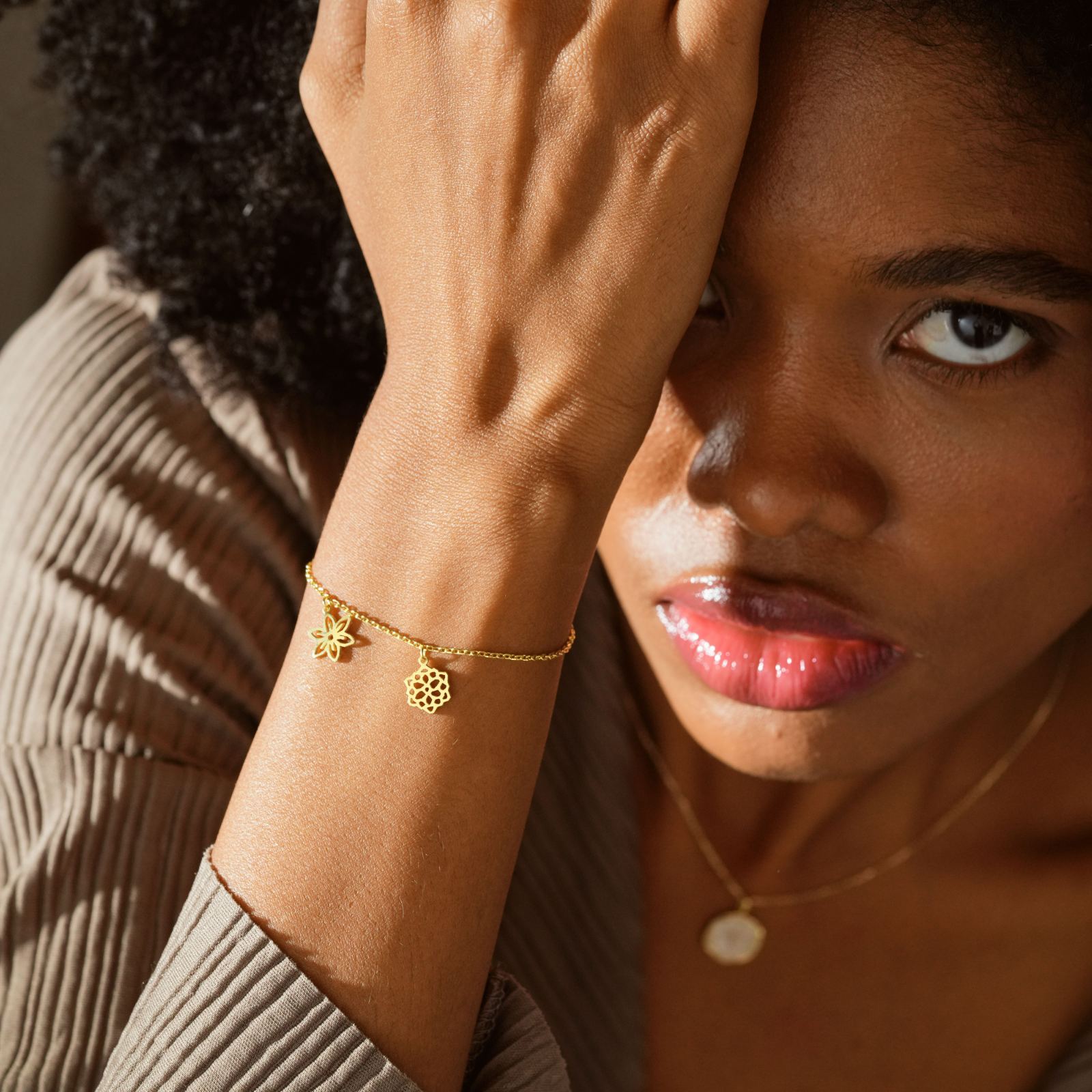 Custom Birth Flower Bracelet showcased on a model's wrist, highlighting gold flower charms, emphasizing meaningful gifts.