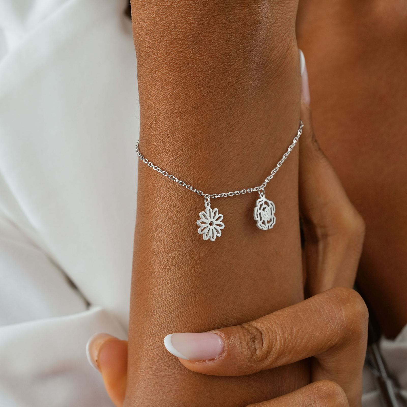 Custom Birth Flower Bracelet with silver flower charms, a perfect gift for meaningful occasions.