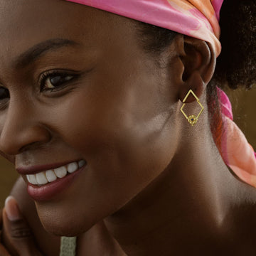 Charming Birth Flower Ear Jacket Earrings worn by a smiling woman with a colorful headscarf.