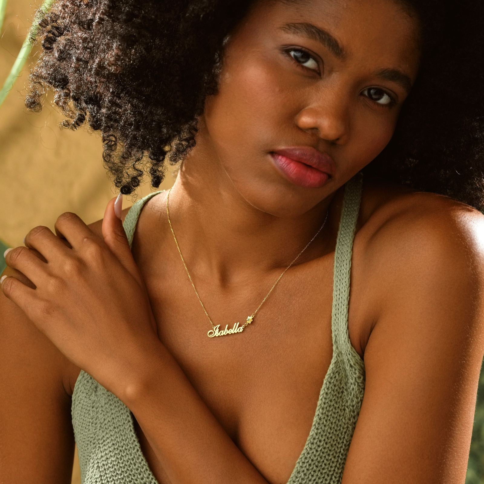 Personalized Birth Flower Name Necklace worn by a woman with curly hair, showcasing the elegant design and craftsmanship.