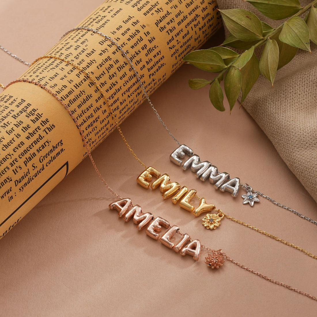 Model showcasing a 3D Bubble Letter Necklace with birth flower detail, emphasizing the personalized name 'EMMA'.