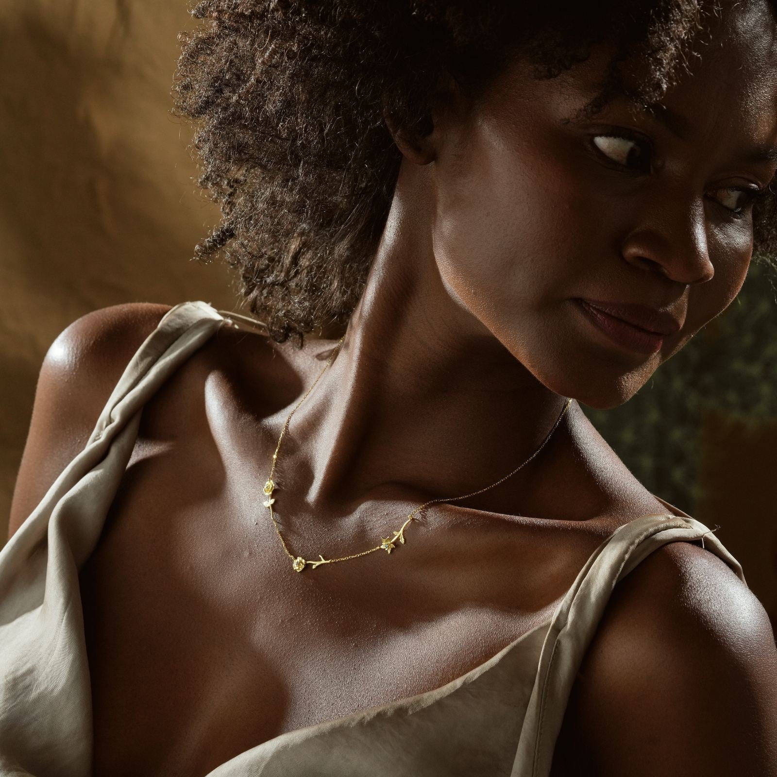 Woman wearing a Personalized Birth Flower Necklace made of high-quality gold vermeil.