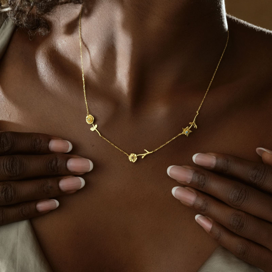 Personalized Birth Flower Necklace worn by a model, featuring gold vermeil and unique birth flower charms.