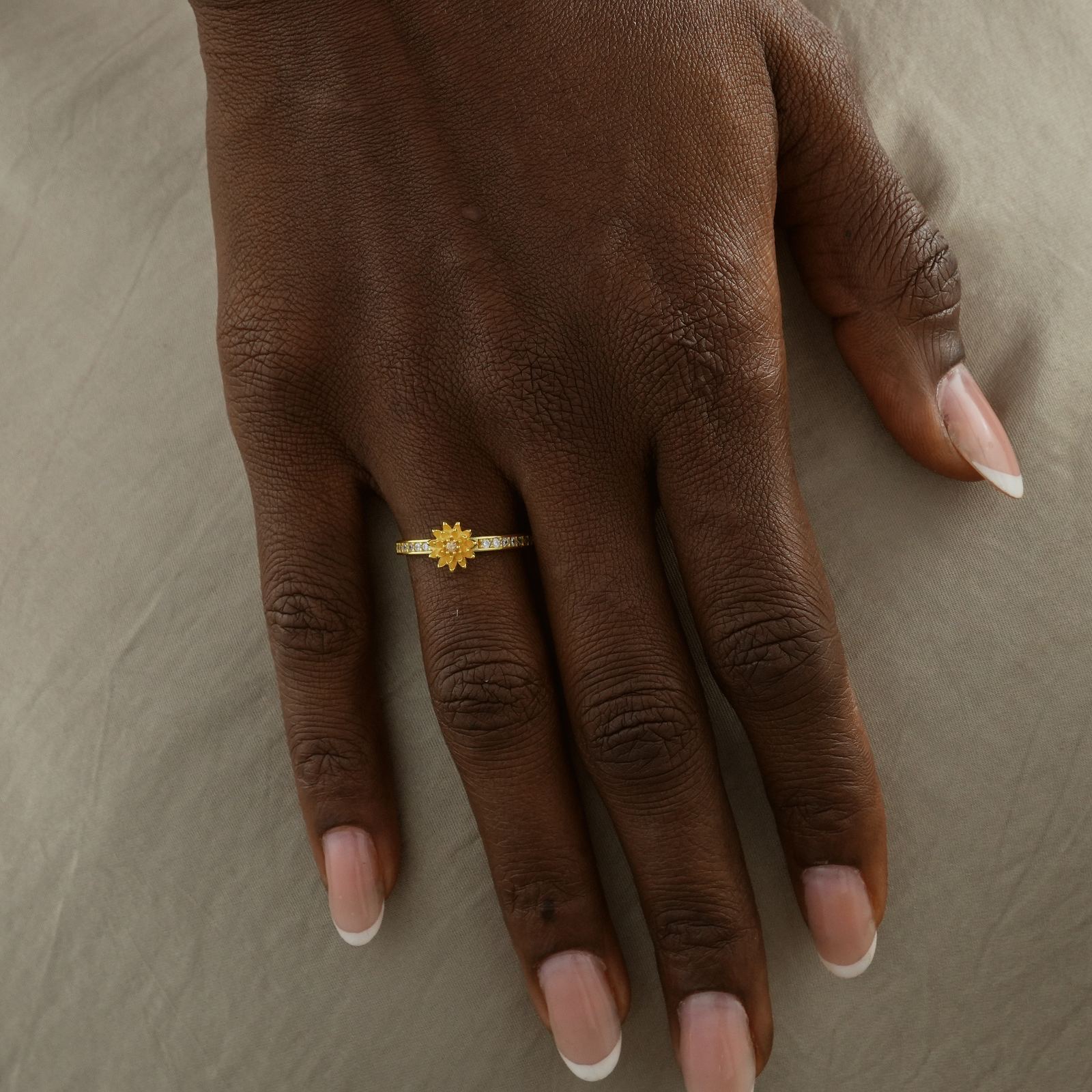 Hand wearing a Personalized Birth Flower Ring in Gold with Cubic Zirconia, showcasing intricate design and quality.