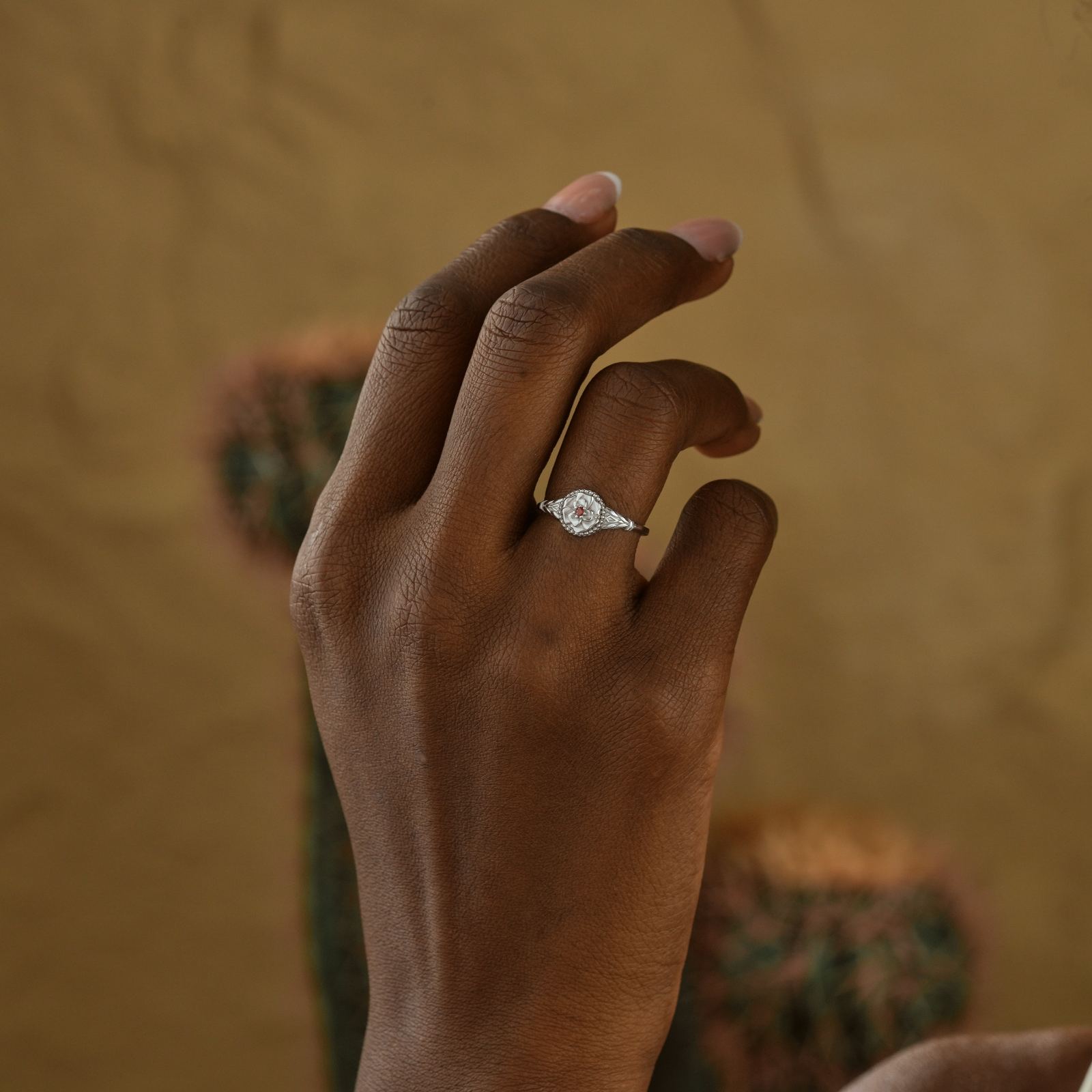 Custom Birth Flower Ring worn on a hand, showcasing intricate design and craftsmanship, perfect for personalized jewelry.