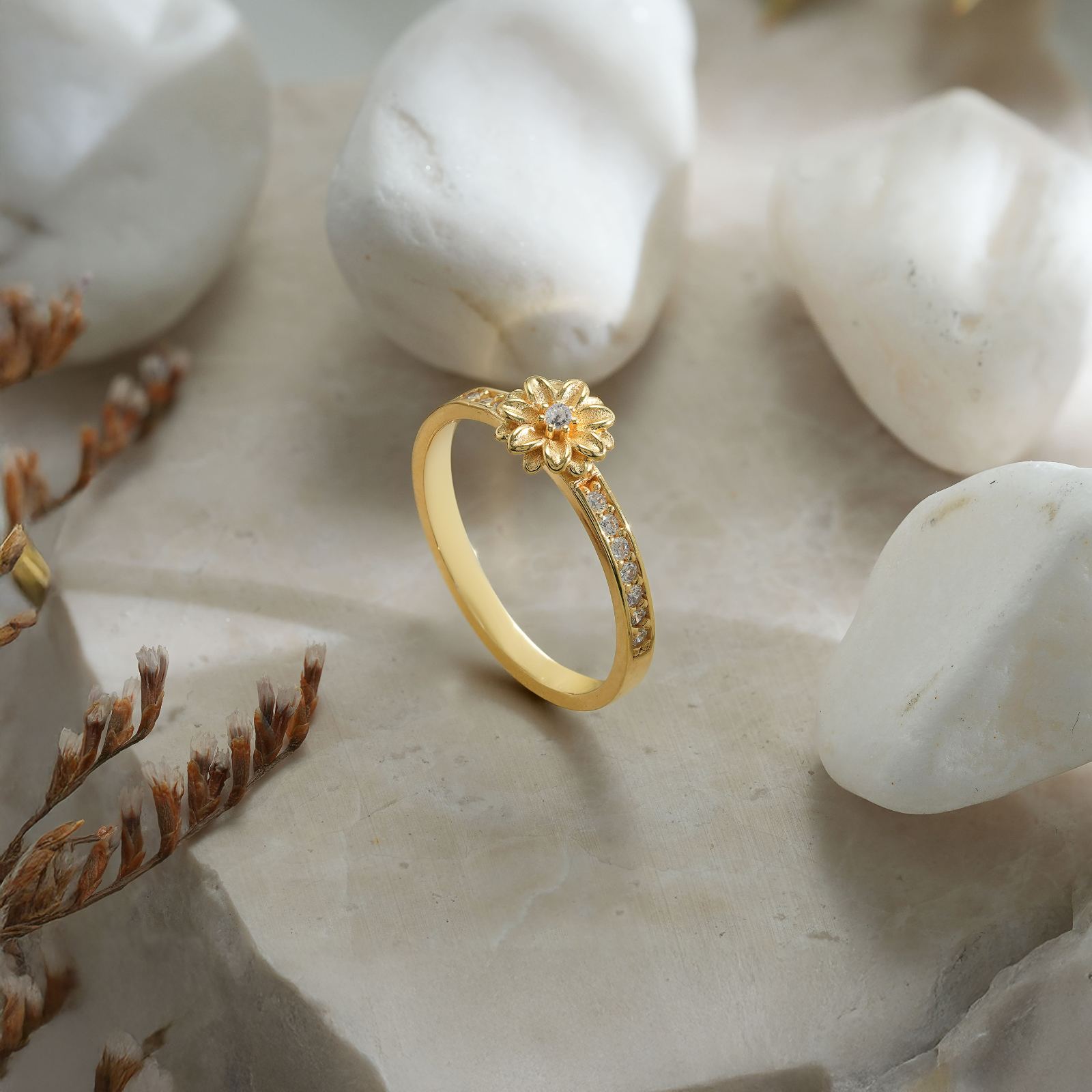 Personalized Birth Flower Ring in Silver Cubic Zirconia displayed on a marble background with decorative stones.