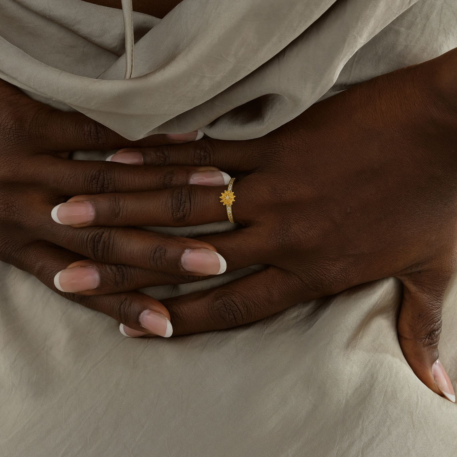 Close-up of hands wearing a Personalized Birth Flower Ring in Silver Cubic Zirconia, showcasing unique design and elegance.