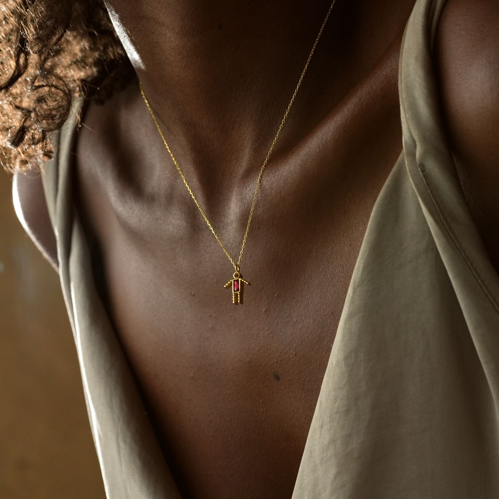 Dainty Boy Birthstone Charm Necklace worn on a model showing a close-up of the gold charm and chain.