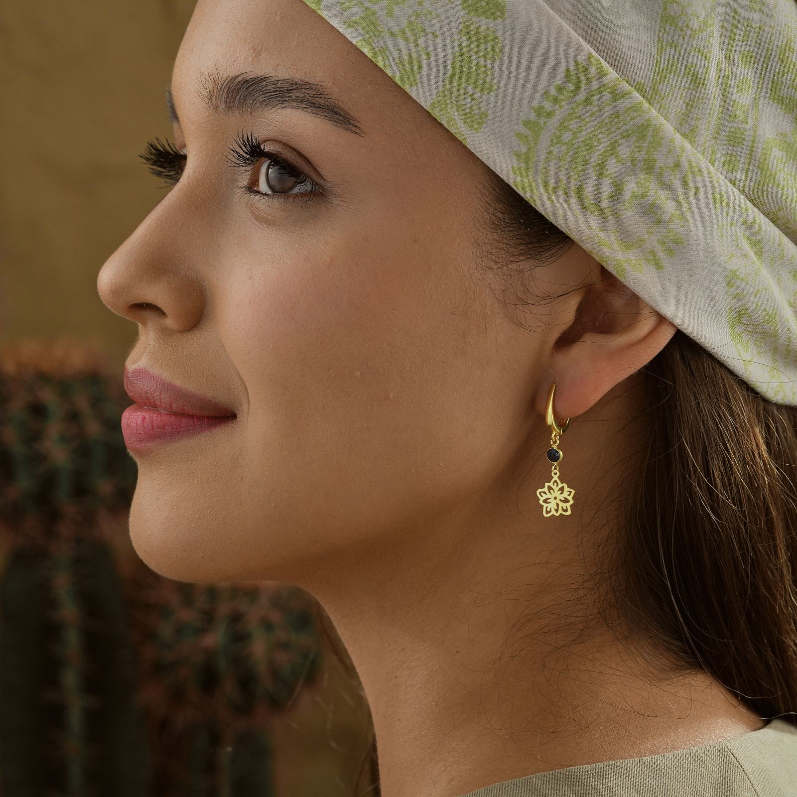 Woman wearing Birthflower Drop Earrings with Birth Stone, showcasing exquisite design against a natural background.