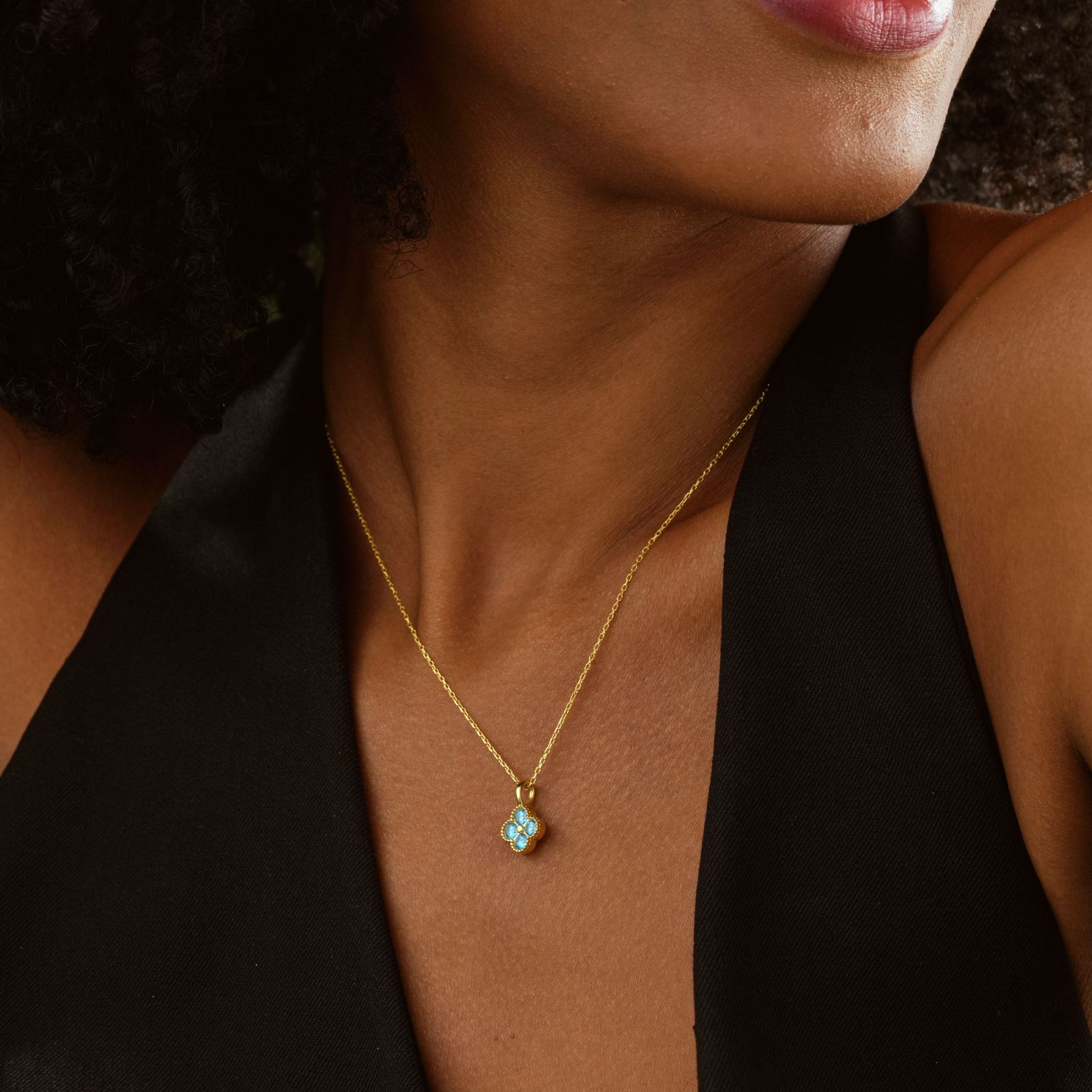 Elegant Clover Birthstone Necklace worn by a woman, showcasing its unique design and sparkling birthstone pendant.