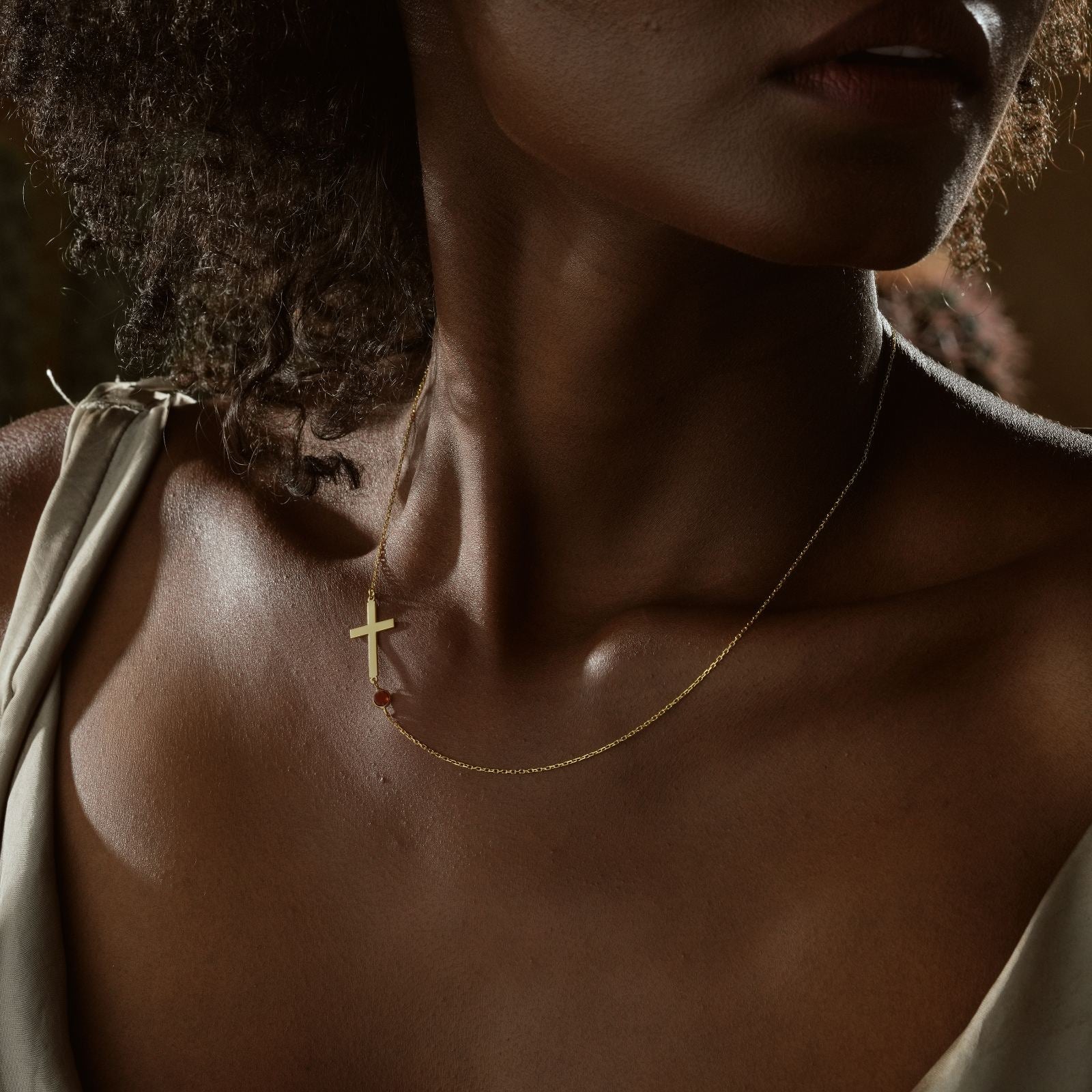 14K Gold Filled Birthstone Cross Necklace worn by a model, showcasing the delicate gold chain and cross design.