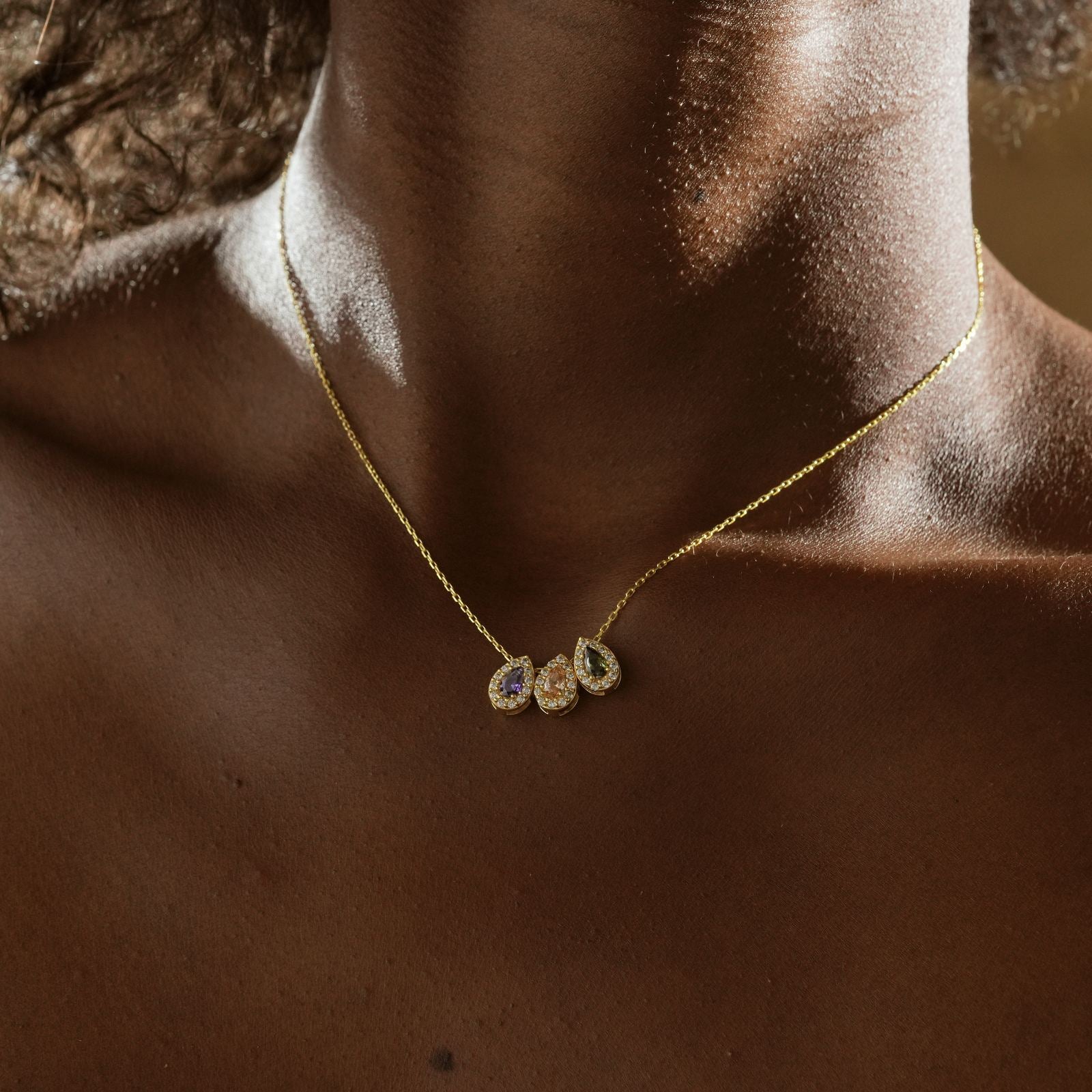 Multiple Teardrop Birthstone Necklace worn on a model with a dark skin tone, highlighting the vibrant gemstones.