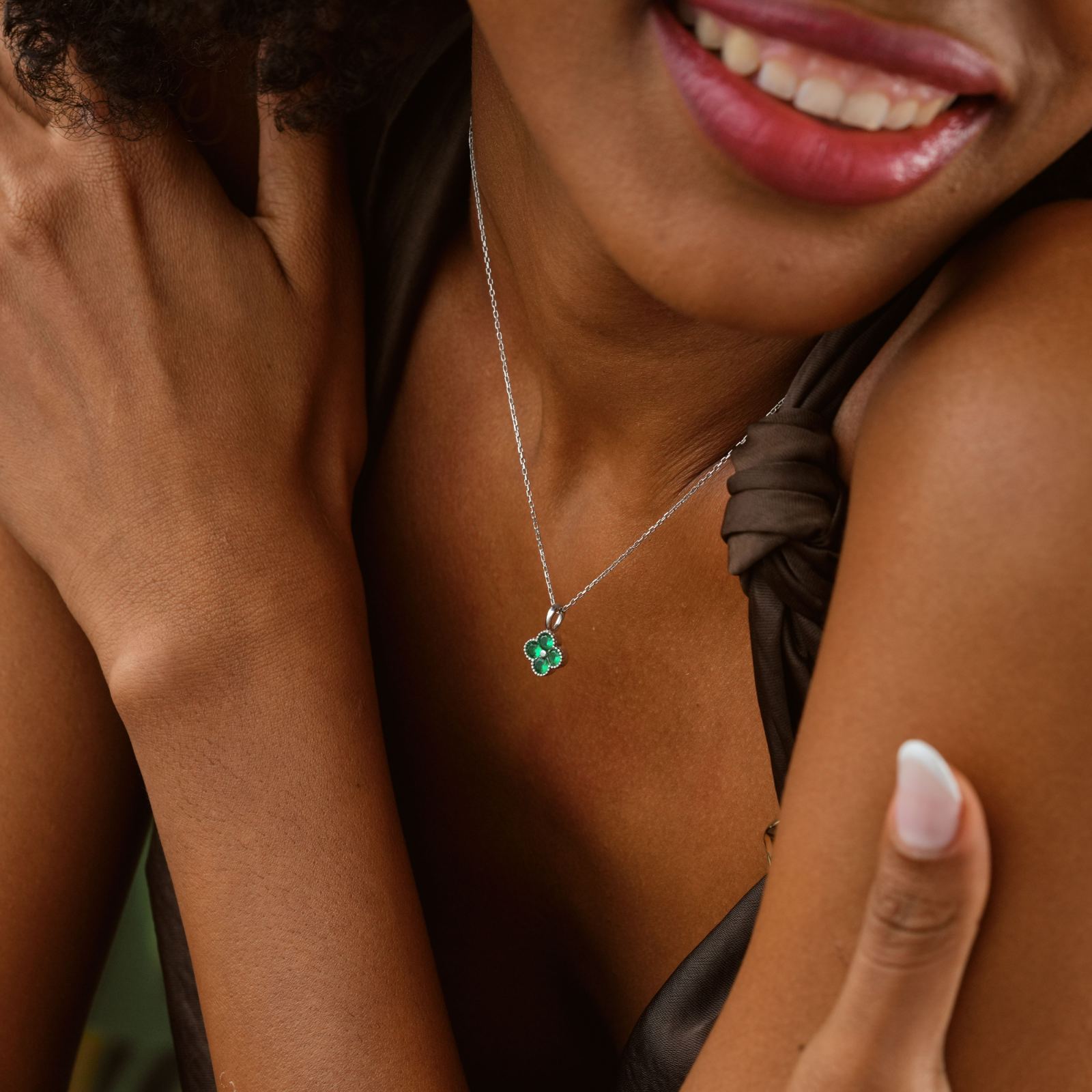 Elegant Clover Birthstone Necklace worn by a model with a dark dress and joyfully smiling.