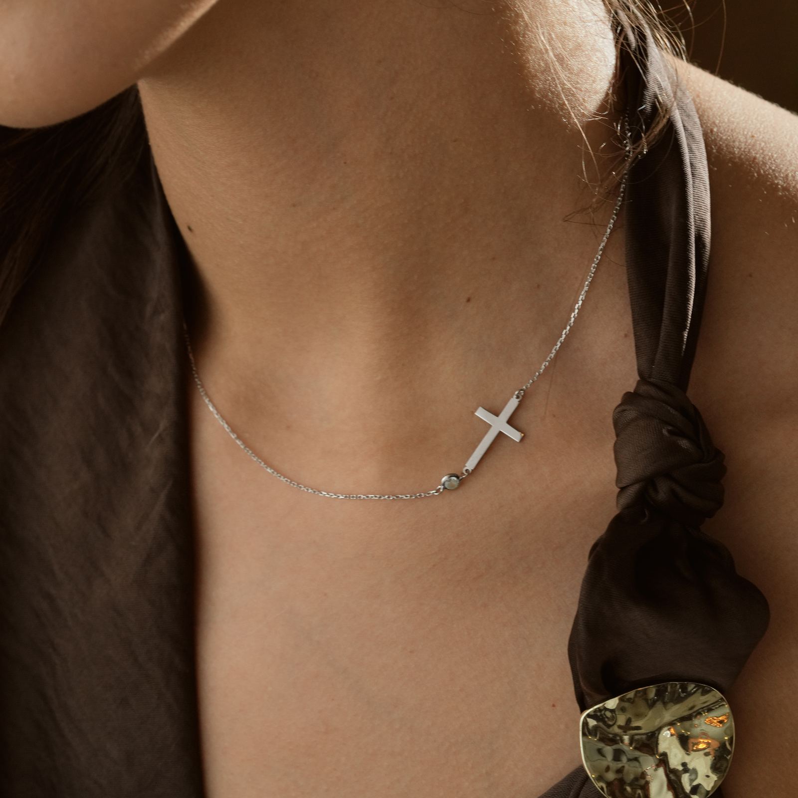 14K Gold Filled Birthstone Cross Necklace worn by a model, showcasing its delicate design and elegant finish.