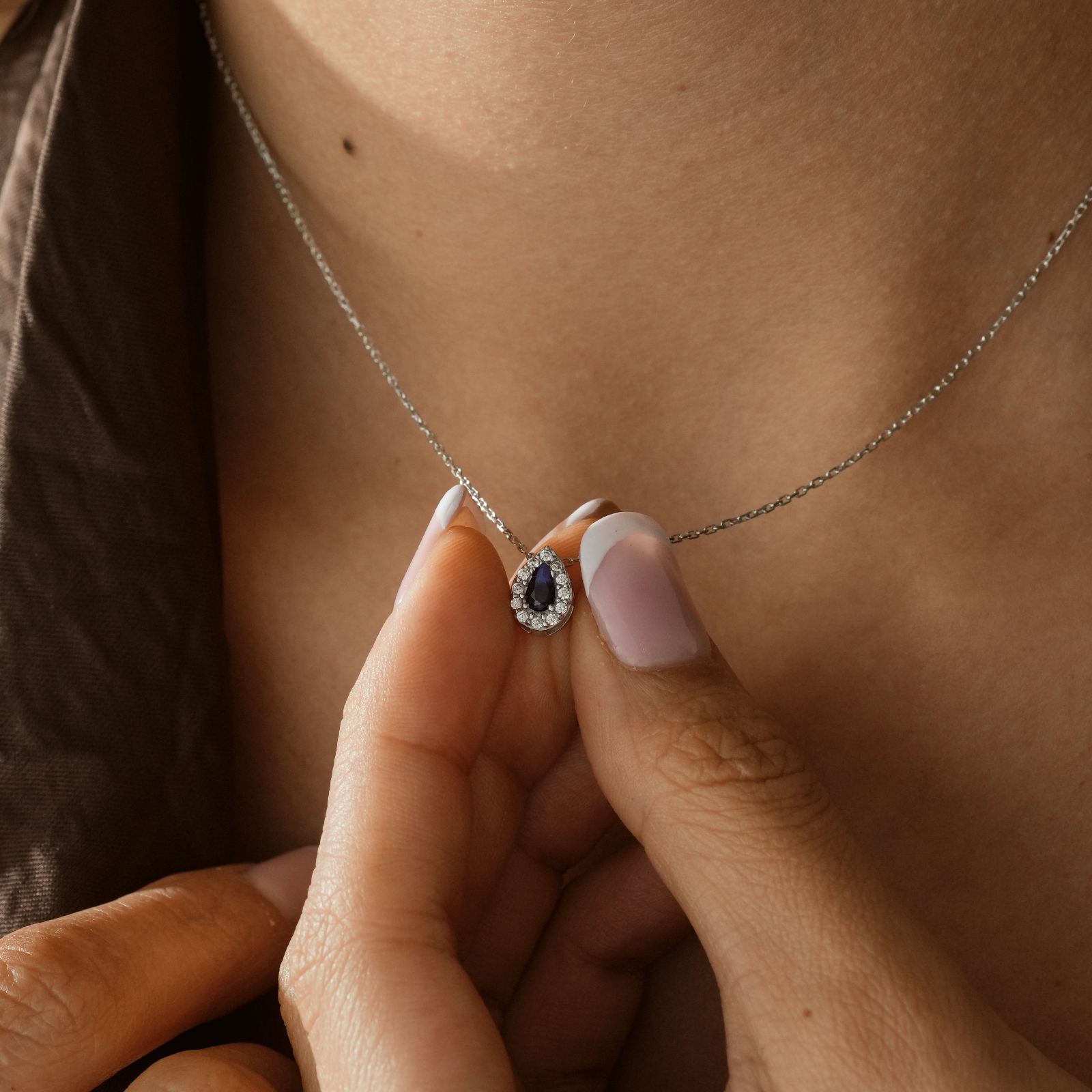 Multiple Teardrop Birthstone Necklace showcased on a person's neck with an elegant teardrop gemstone pendant.