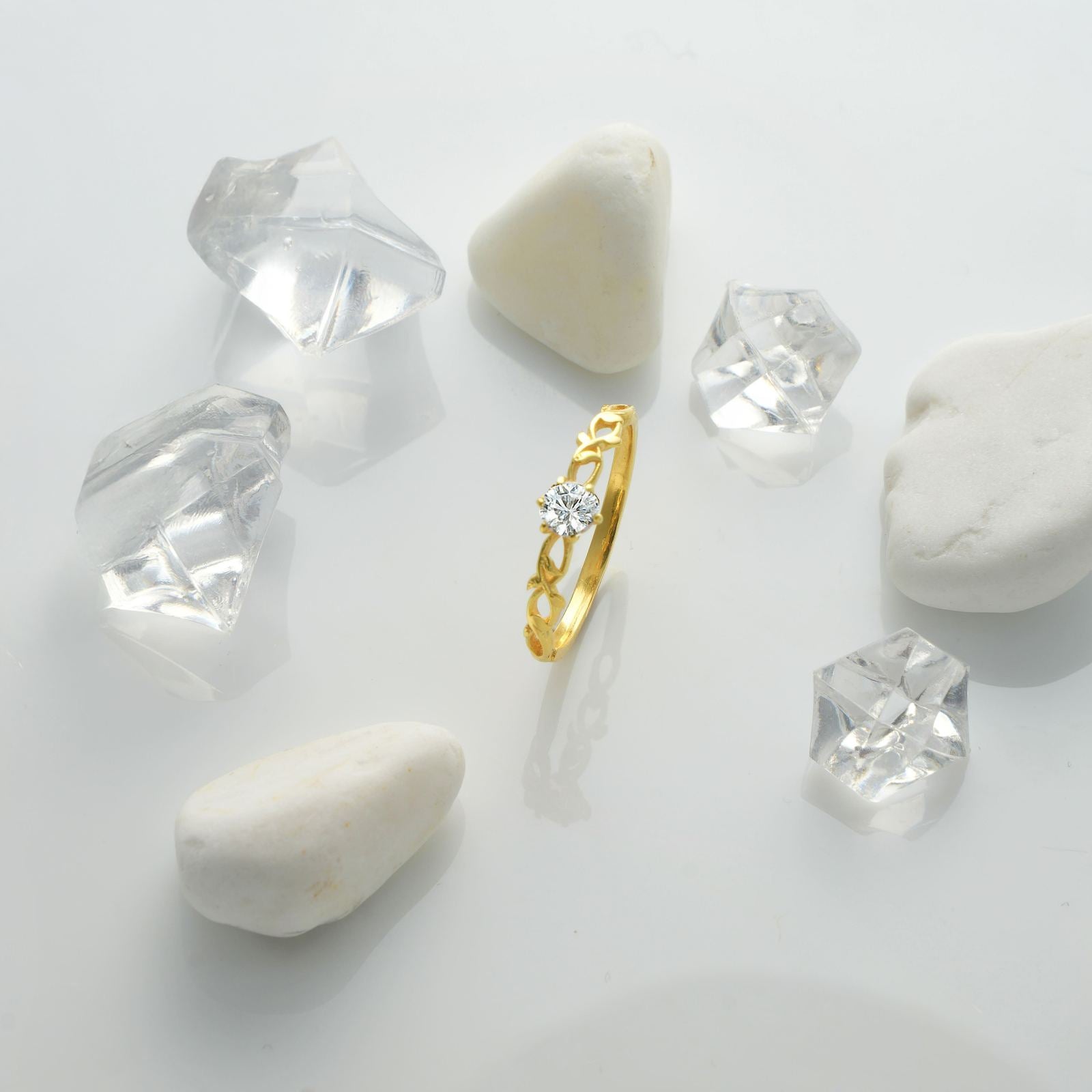 Nature-Inspired Floral Birthstone Ring surrounded by crystals on a smooth surface.