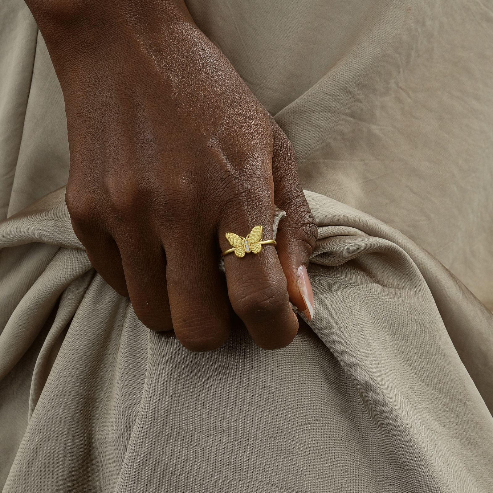 Dainty Butterfly Birthstone Ring worn on a hand with a gold finish, showcasing unique style and elegant design.