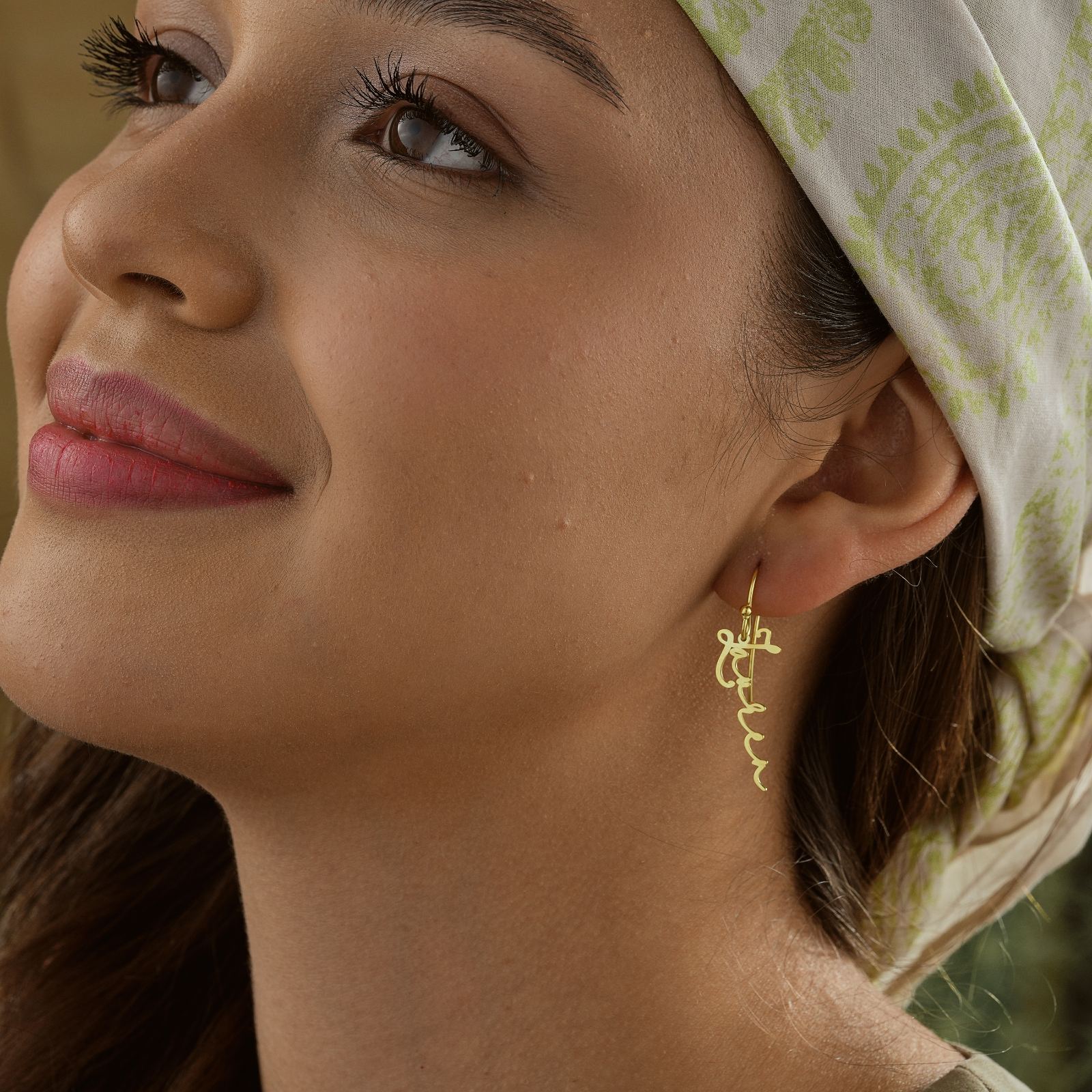 Model wearing Personalized Name Earrings in sterling silver, showcasing the delicate design and shine.