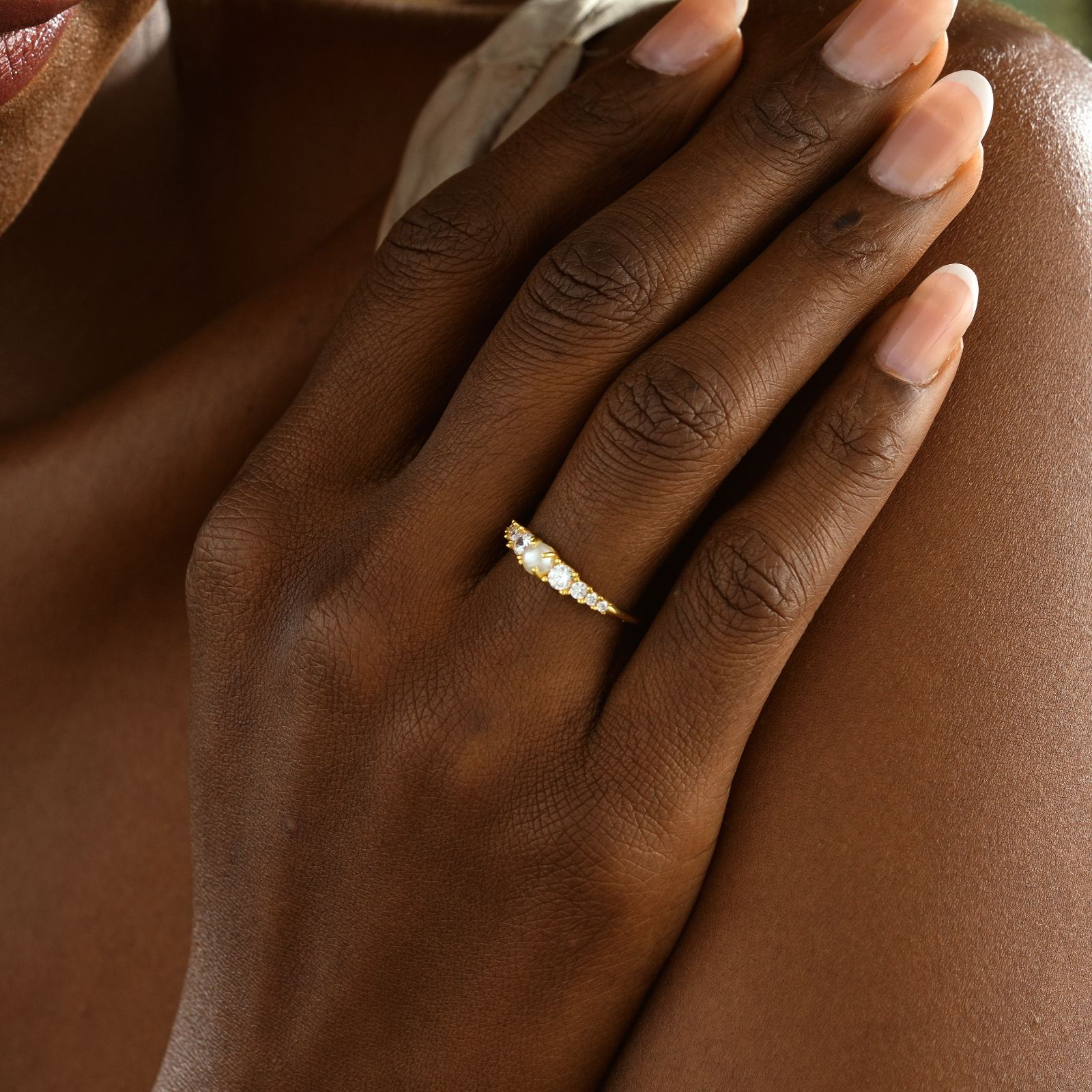 Close-up of a hand wearing a Vintage Cross Signet Ring with CZ diamonds in yellow gold.