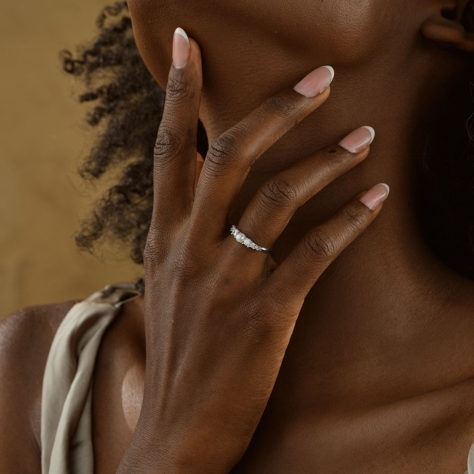 Wearing a Vintage Cross Signet Ring with CZ Diamond on elegant finger.
