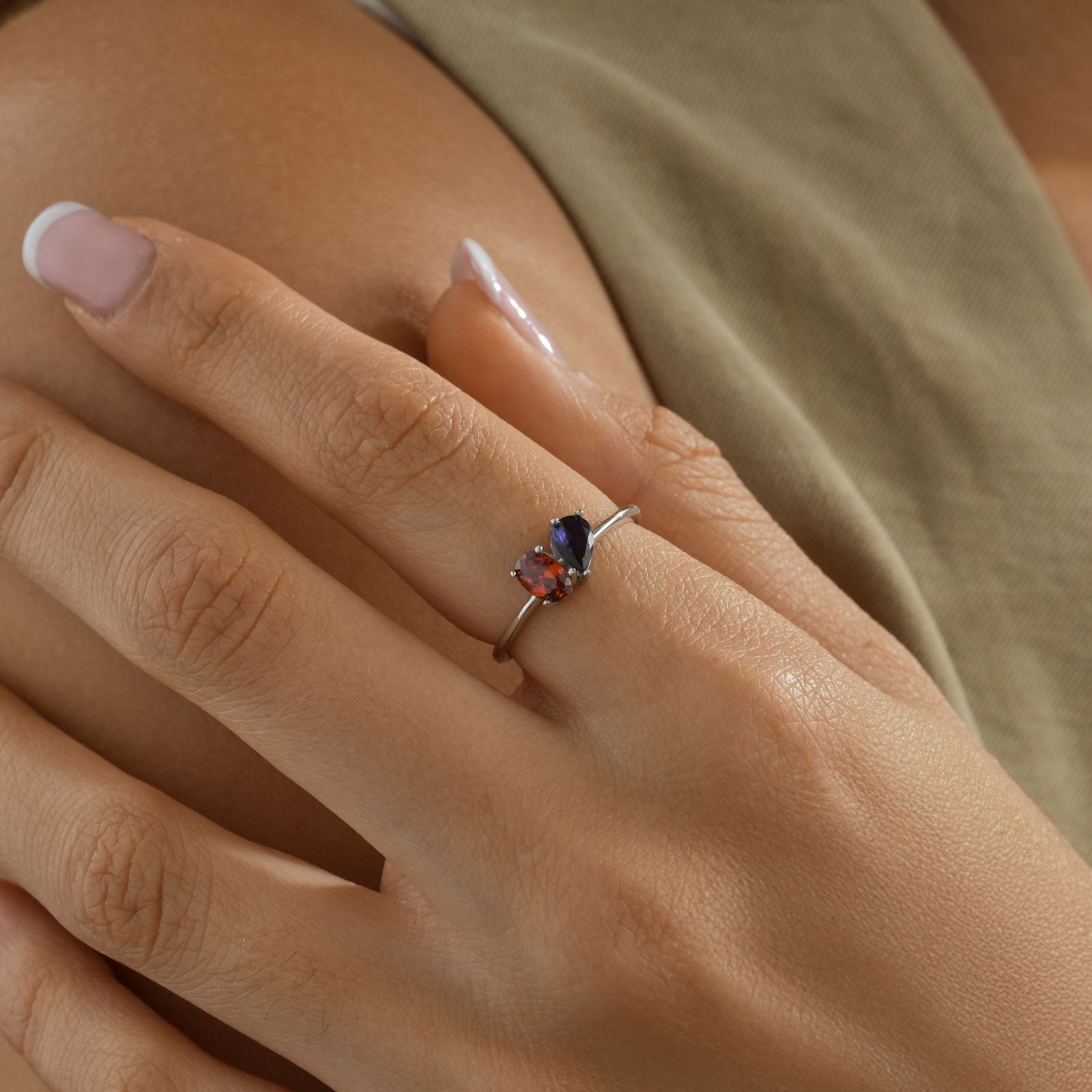 Oval & Pear Cut Birthstone Ring worn on a hand, featuring gemstones and high-quality silver setting.