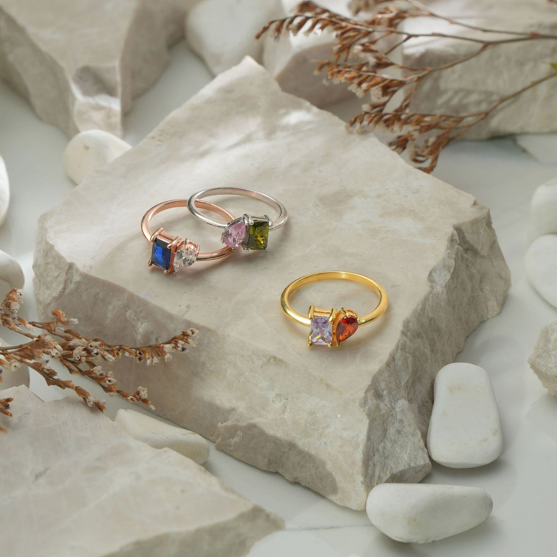 Woman wearing an Oval & Emerald Cut Birthstone Ring on her hand, showcasing its elegant design.