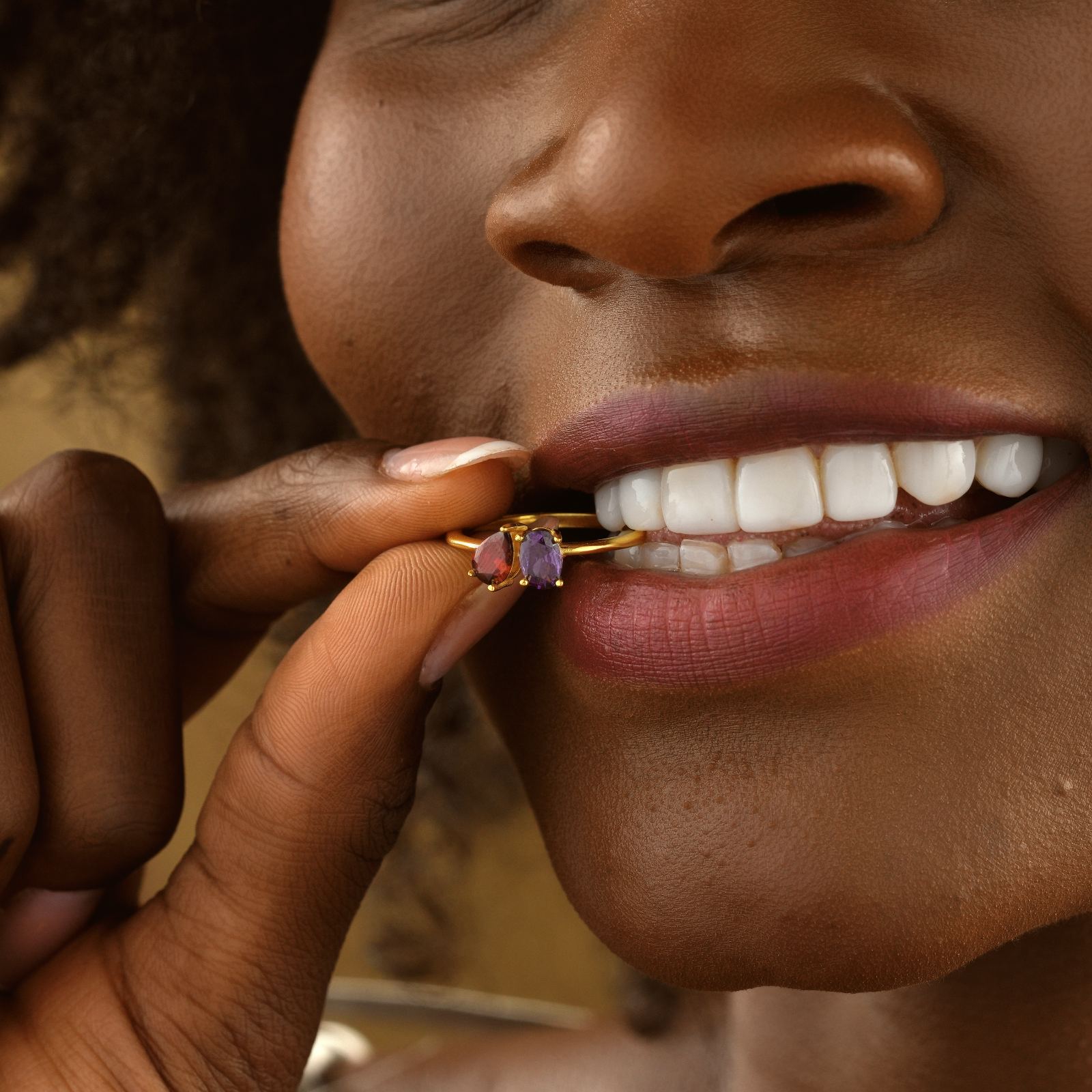 Woman showcasing an Oval & Pear Cut Birthstone Ring with vibrant stones and gold vermeil finish.