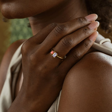 Woman wearing an Oval & Emerald Cut Birthstone Ring on her hand, showcasing its elegant design.