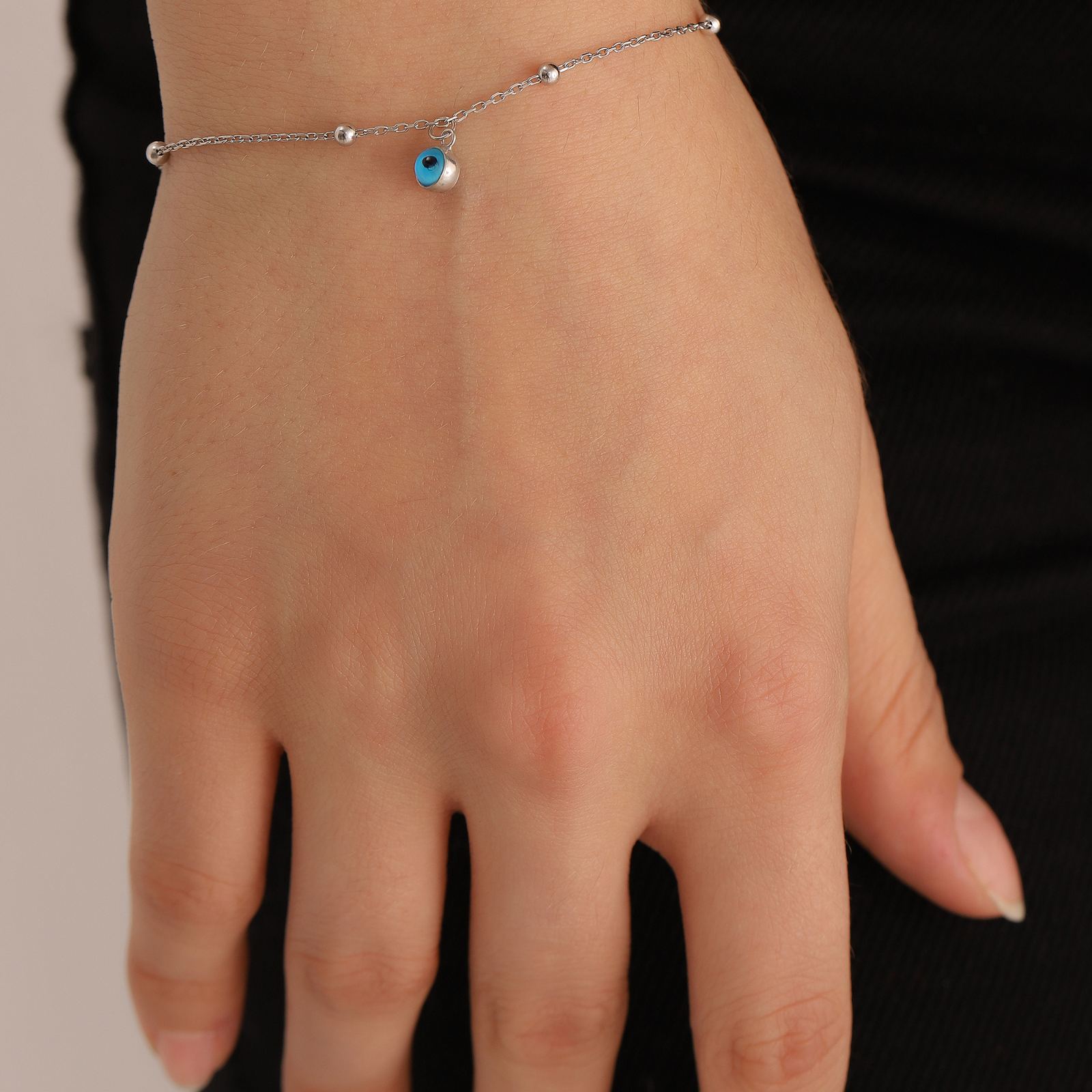 Charming Evil Eye Bracelet featuring high-quality sterling silver with a blue evil eye charm.