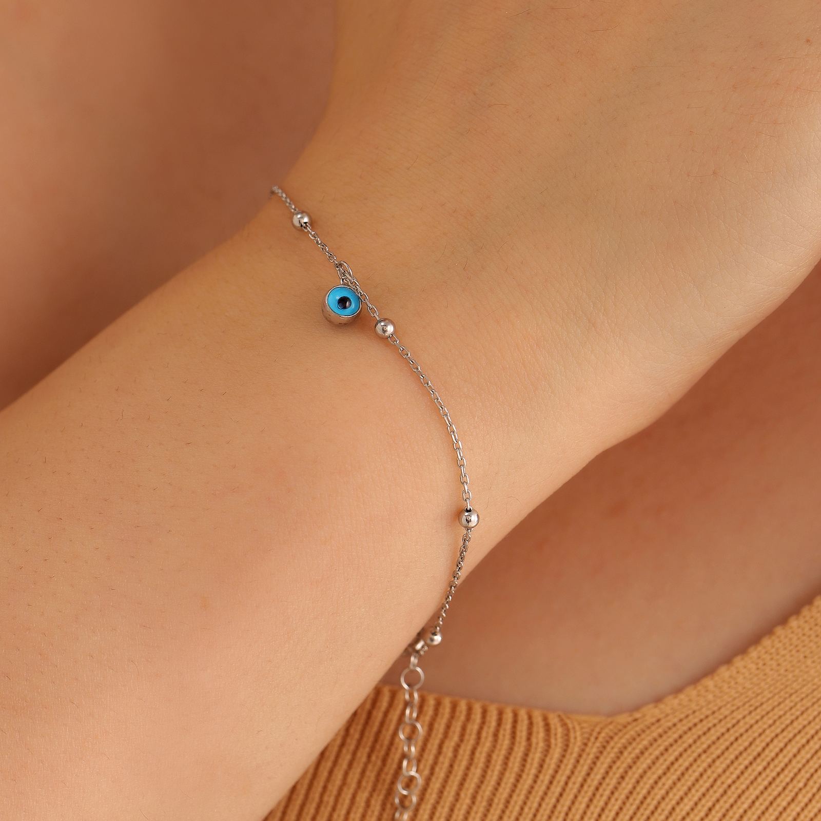 Charming Evil Eye Bracelet Sterling Silver worn on wrist with evil eye charm and delicate chain.