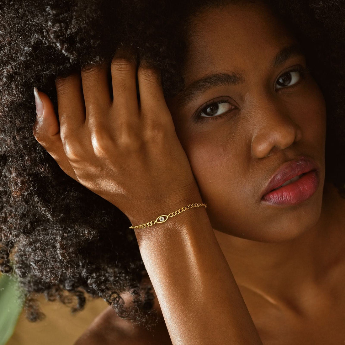 Evil Eye Curb Chain Bracelet on model's wrist, showcasing elegant design in gold vermeil.
