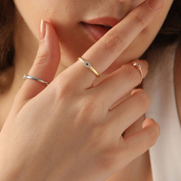 Evil Eye Ring Silver styled on hand, featuring sterling silver and sapphire gemstone, showcasing various band finishes.