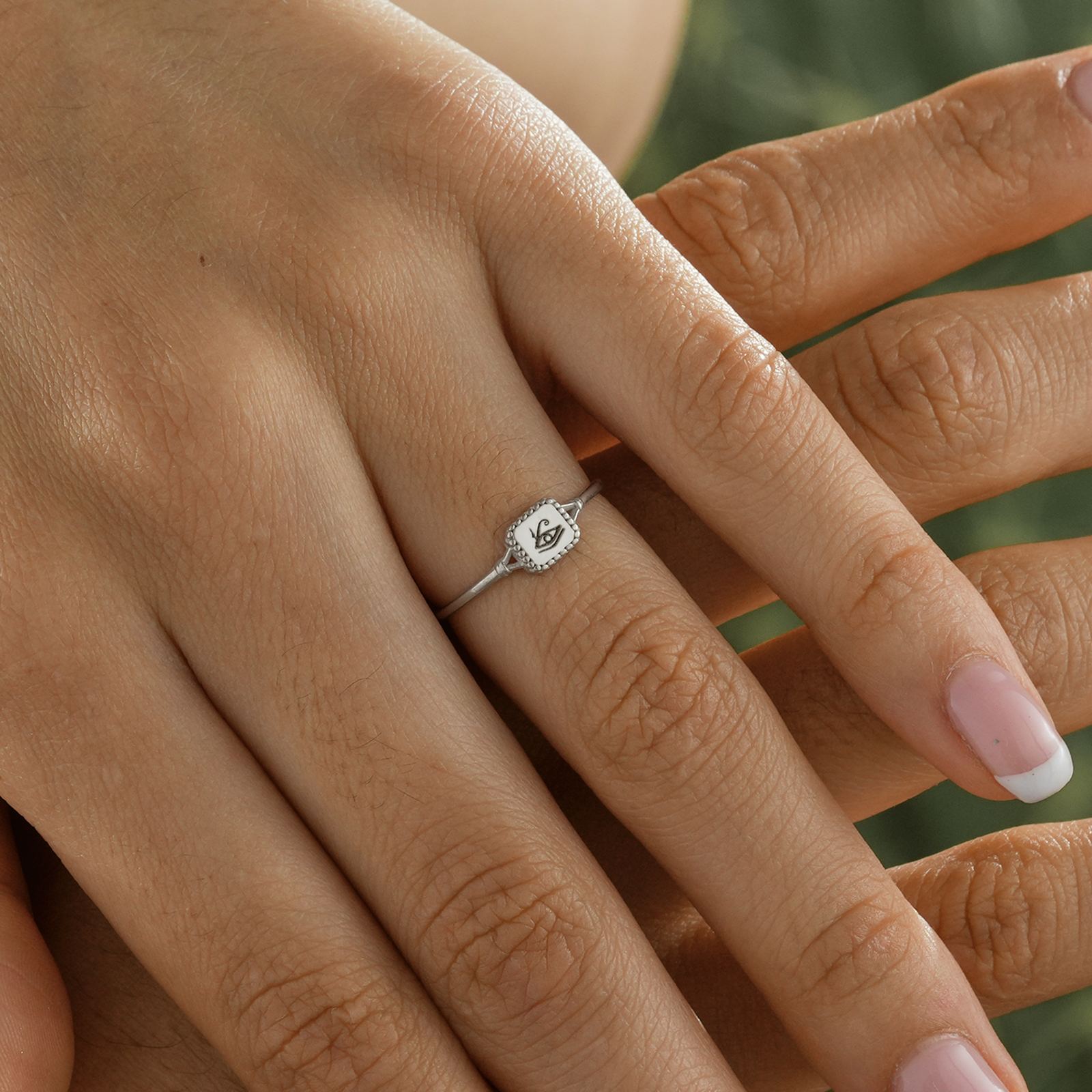Close-up of Eye of Ra Signet Ring on hand showcasing its detailed design in high-quality sterling silver.