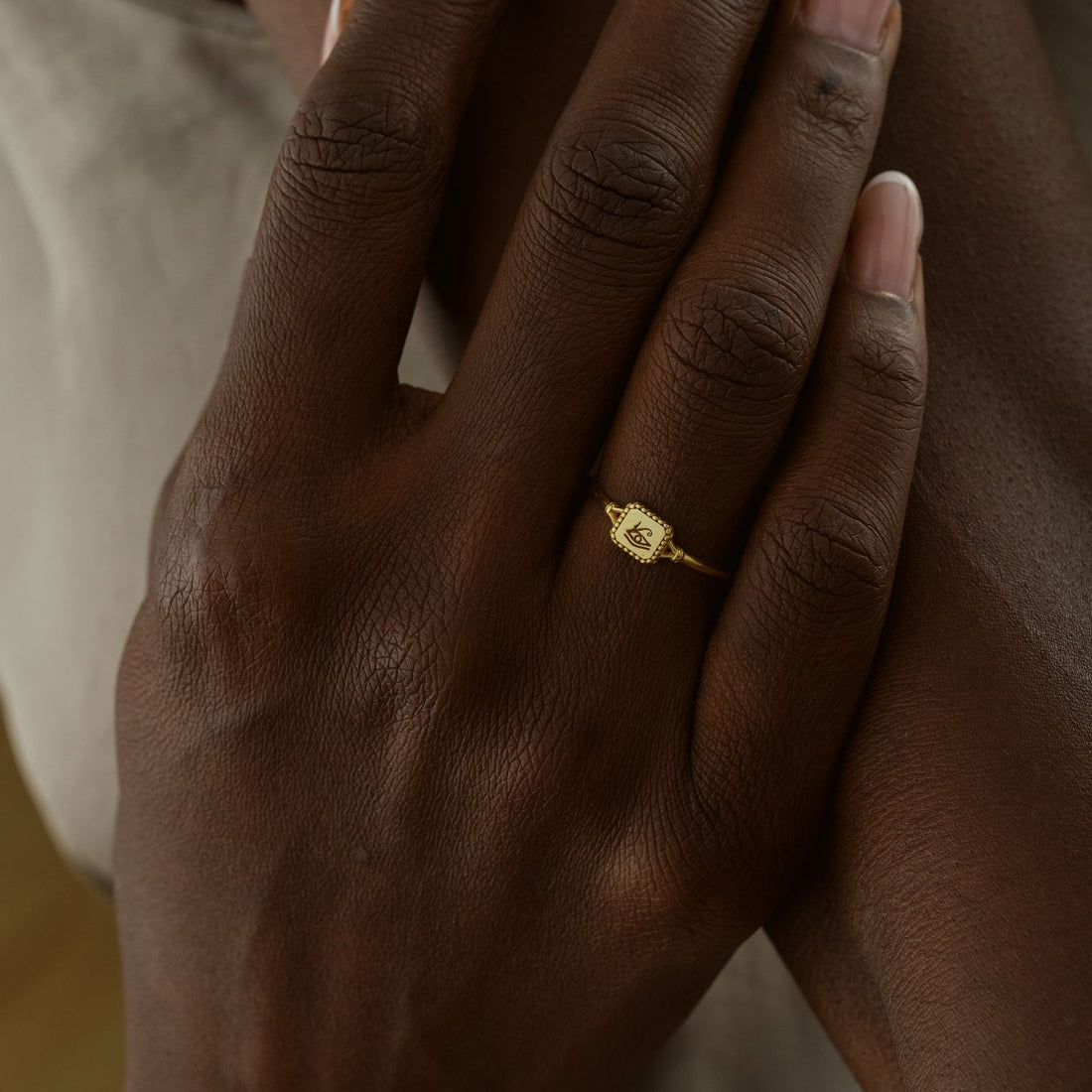 Hand wearing an Eye of Ra Signet Ring in gold vermeil, showcasing elegant jewelry design.