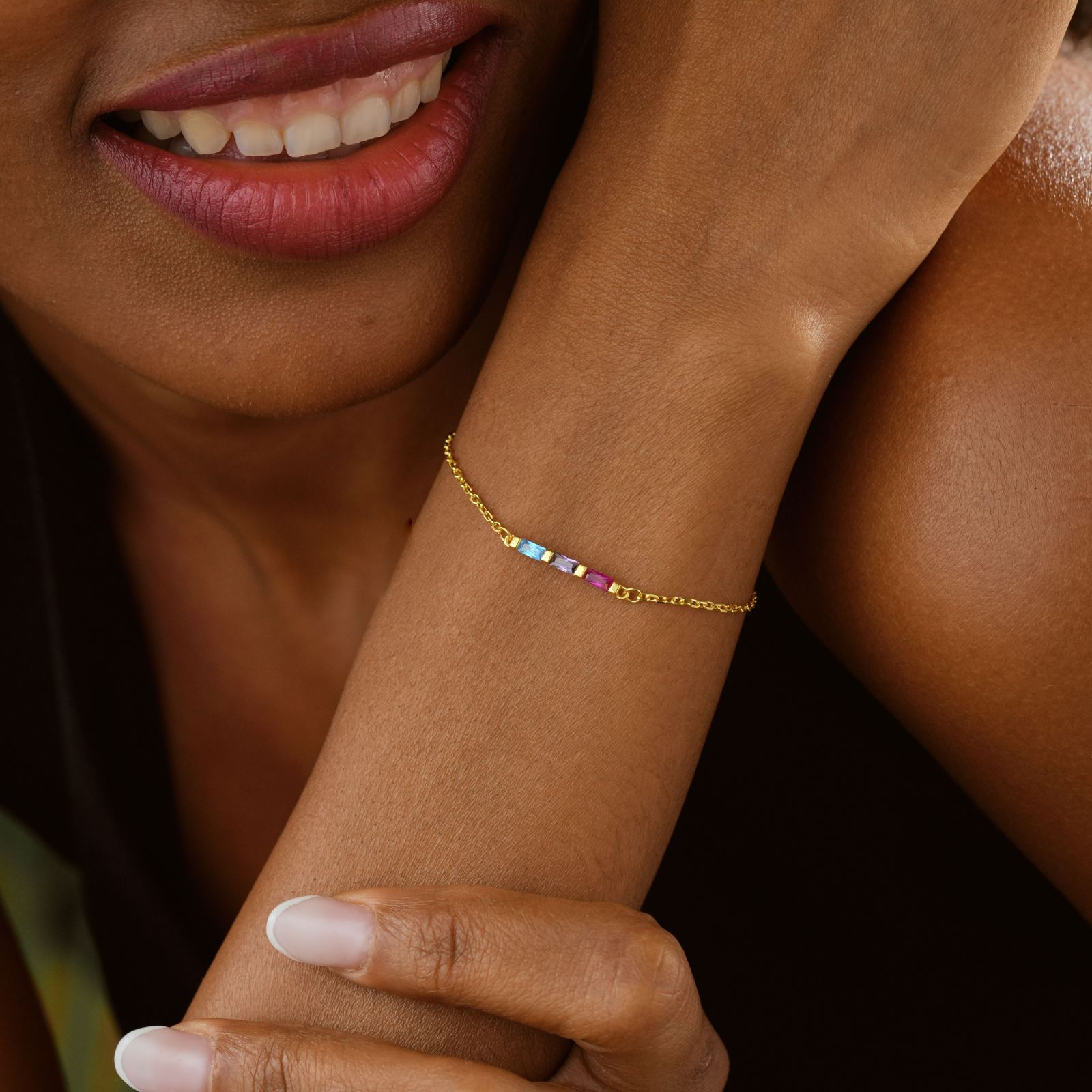 Elegant Gold Filled Birthstone Bracelet worn on a model's wrist, showcasing colorful birthstones and a gold-filled chain.