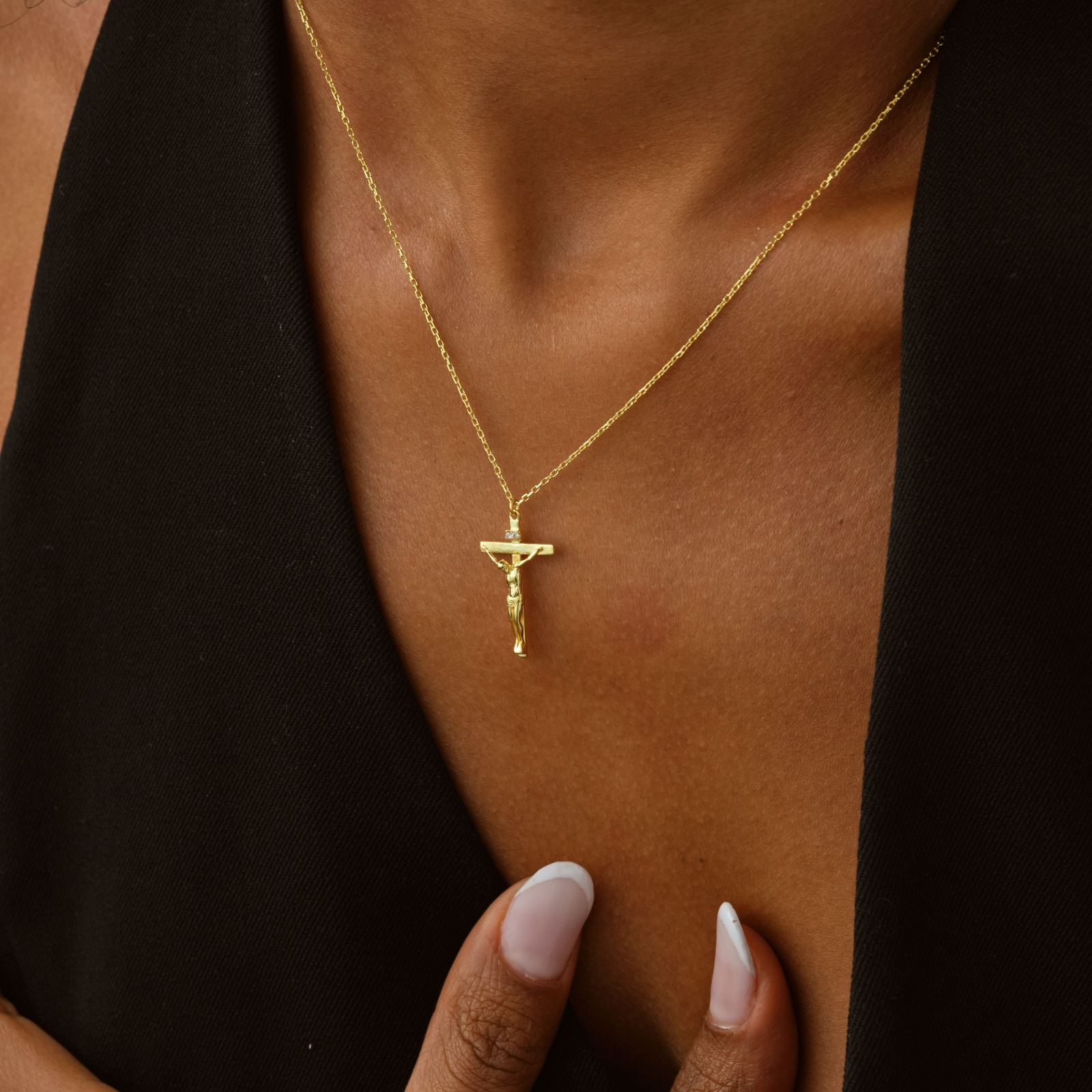14K Solid Gold Filled Crucifix Necklace worn by a person, showcasing its minimalist design and gold color.