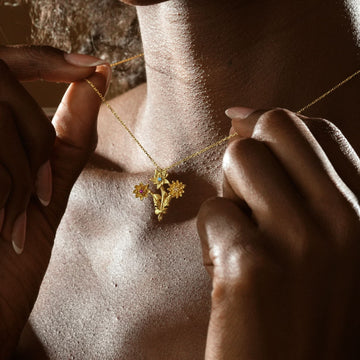 Gold Filled Birth Flower Bouquet Necklace worn by a person, showcasing delicate floral design in gold.