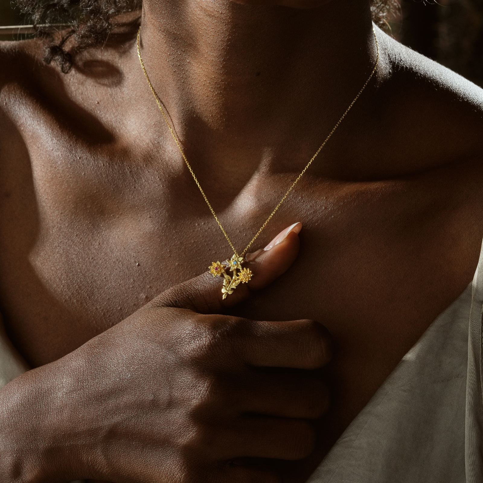Gold Filled Birth Flower Bouquet Necklace worn by a model, highlighting detailed floral design on a gold chain.