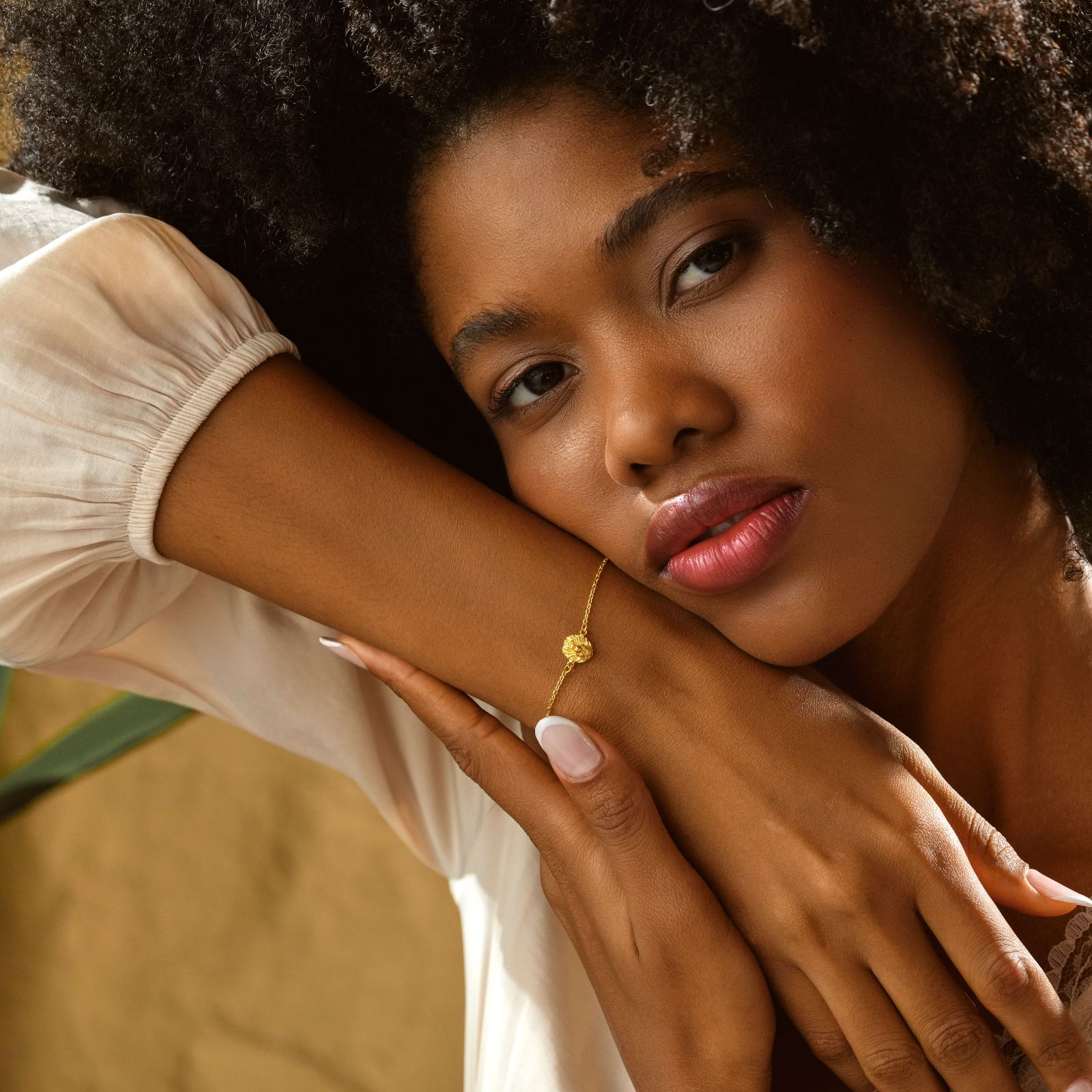 Woman wearing Lion Pendant Bracelet Minimalist in gold, showcasing elegant minimalist jewelry style.