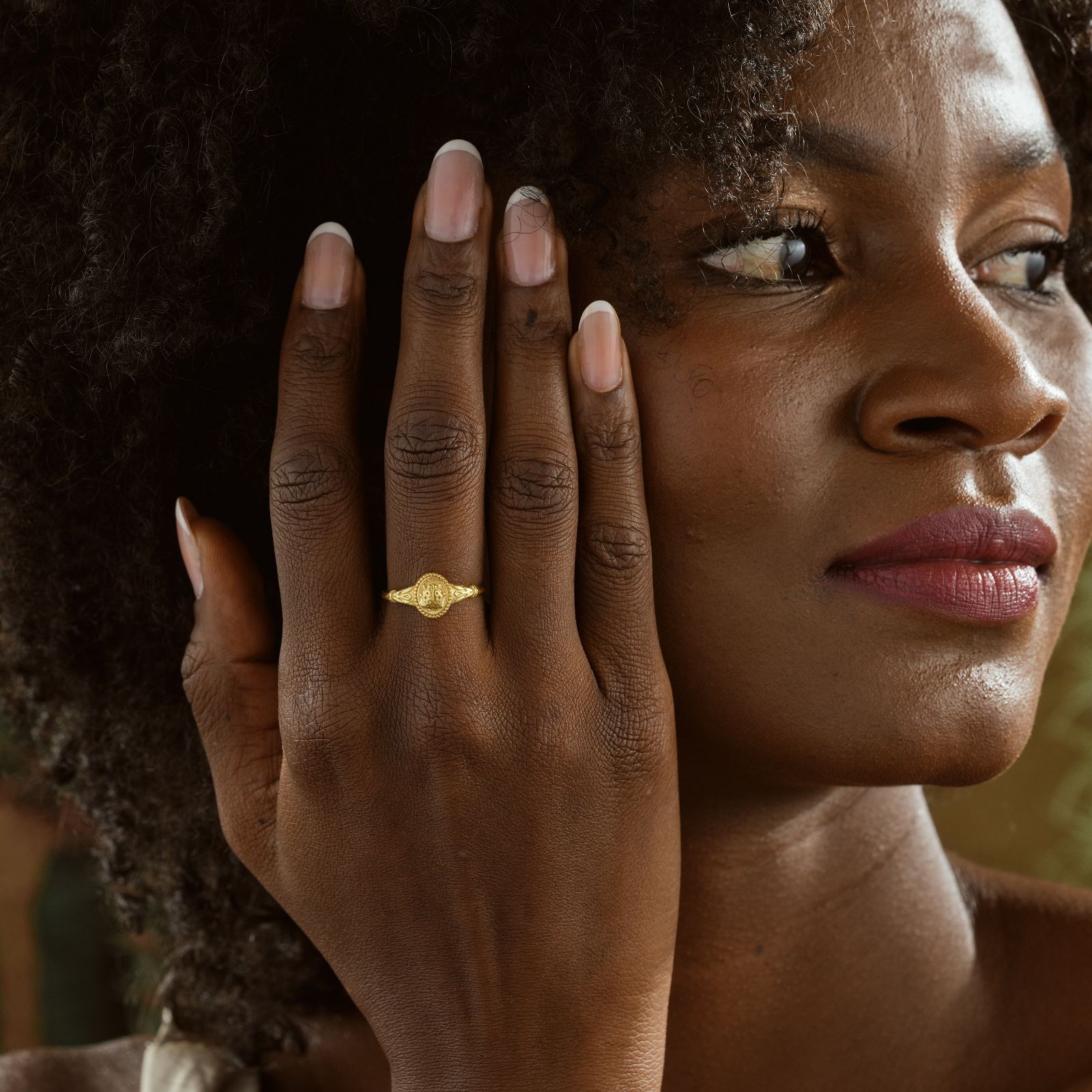 Woman wearing a Ladybug Signet Ring, showcasing elegant design in gold vermeil finish.