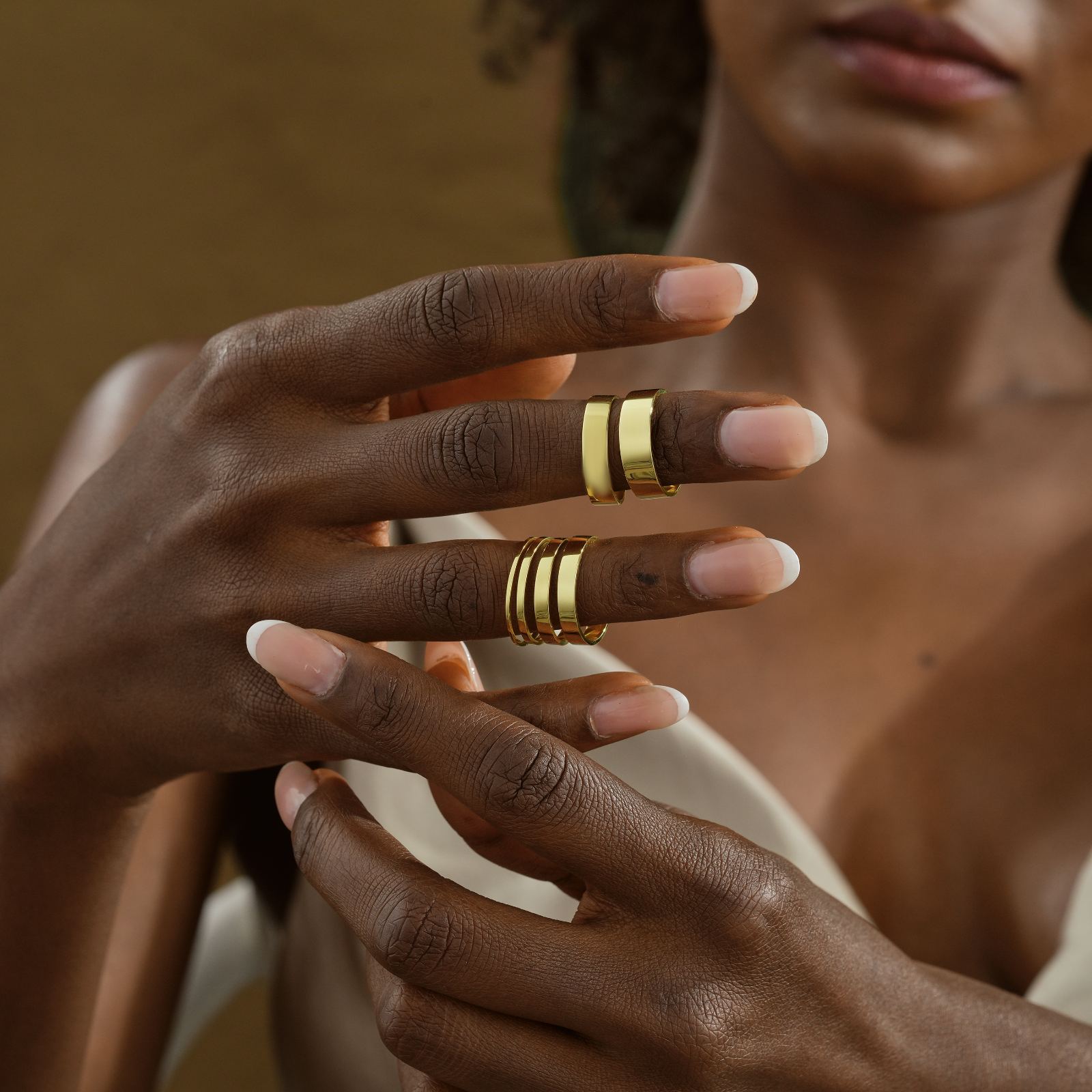 Thin Wedding Band Minimalist Stacking Ring shown on model's hands with elegant gold finish.