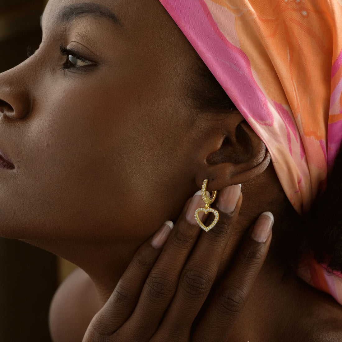 Elegant Heart Hoop Earring for Her worn by a woman with a pink scarf in a close-up shot.