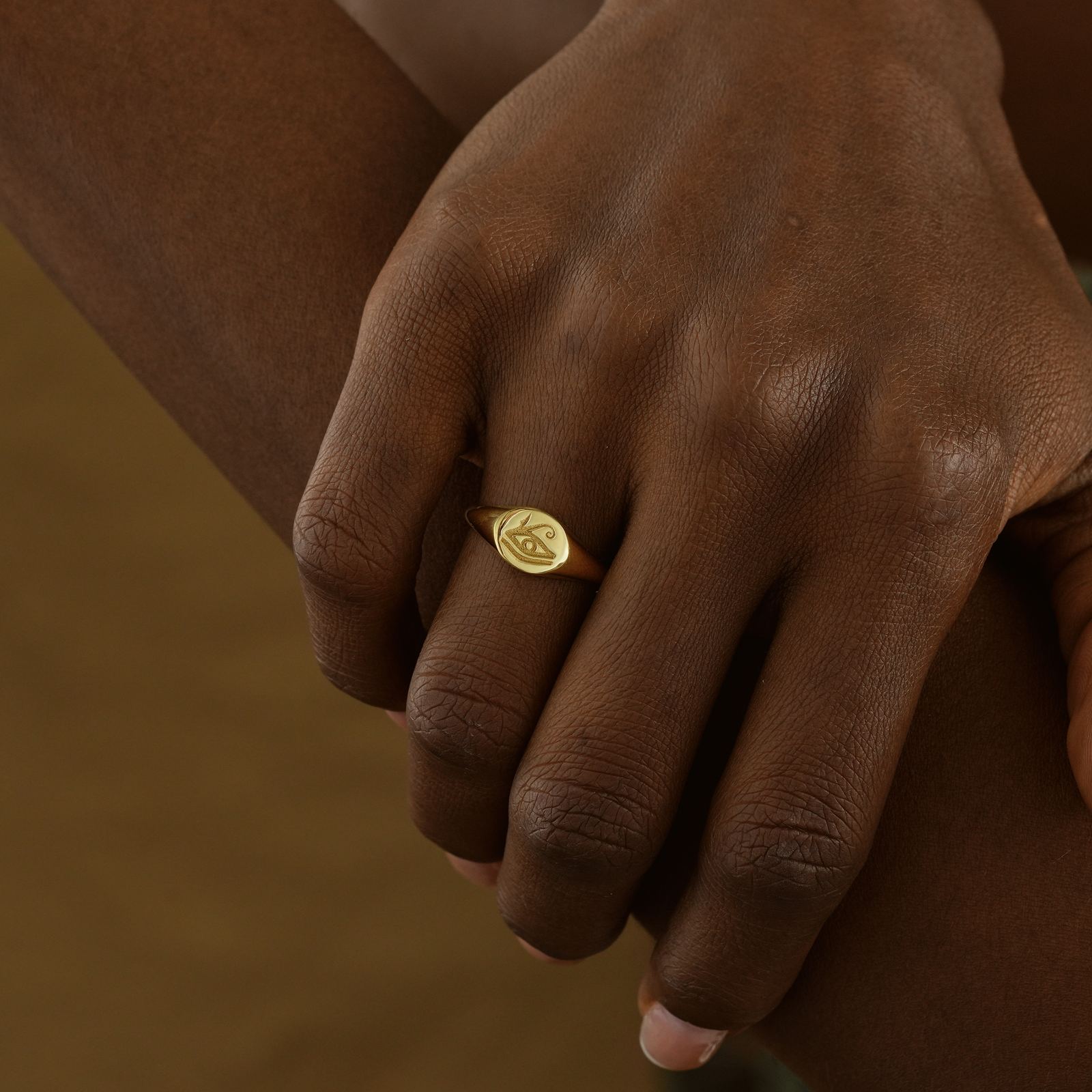 Horus Eye Signet Ring worn on a hand, showcasing its gold vermeil finish and unique design.