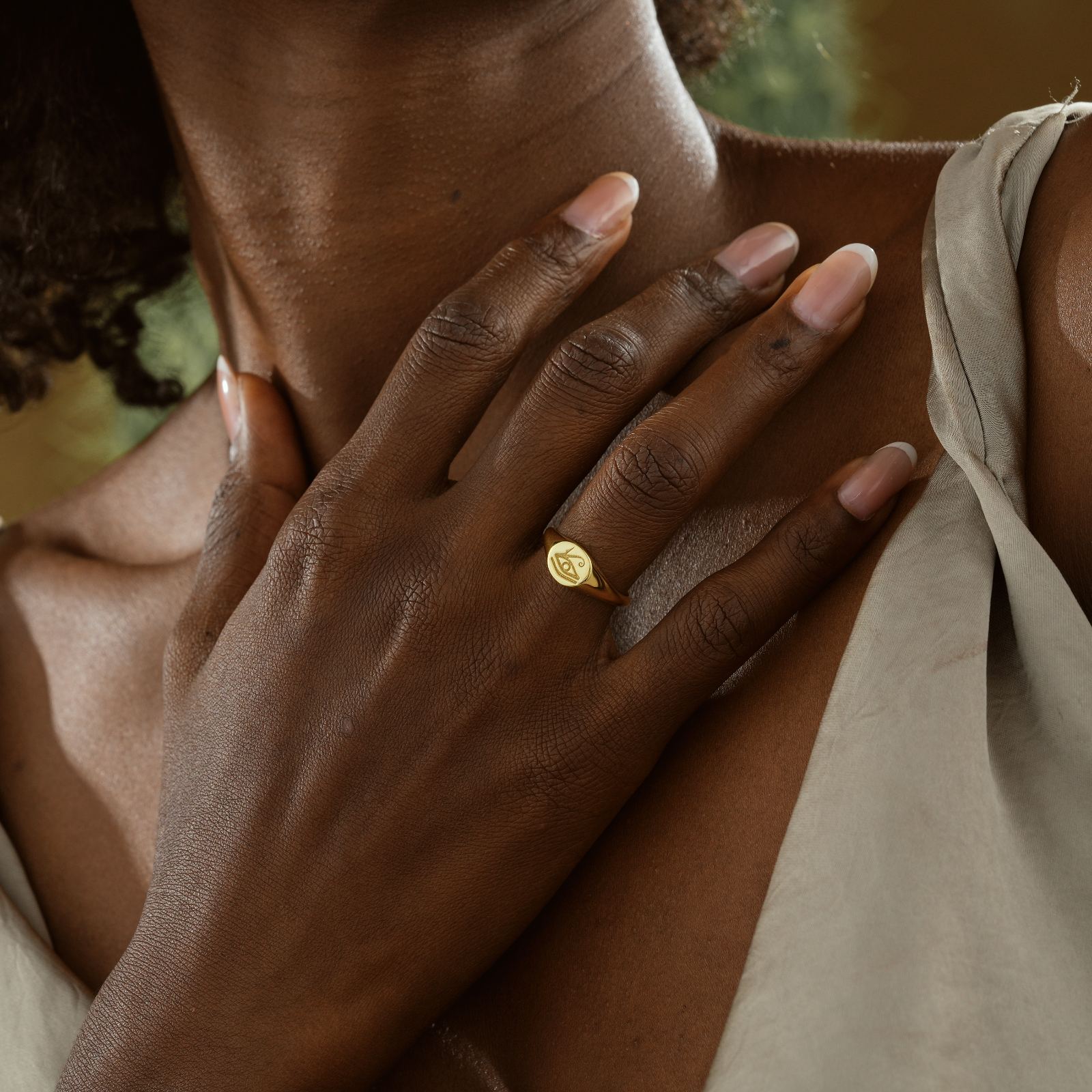 Horus Eye Signet Ring worn on elegant hand showcasing gold vermeil finish and intricate design.