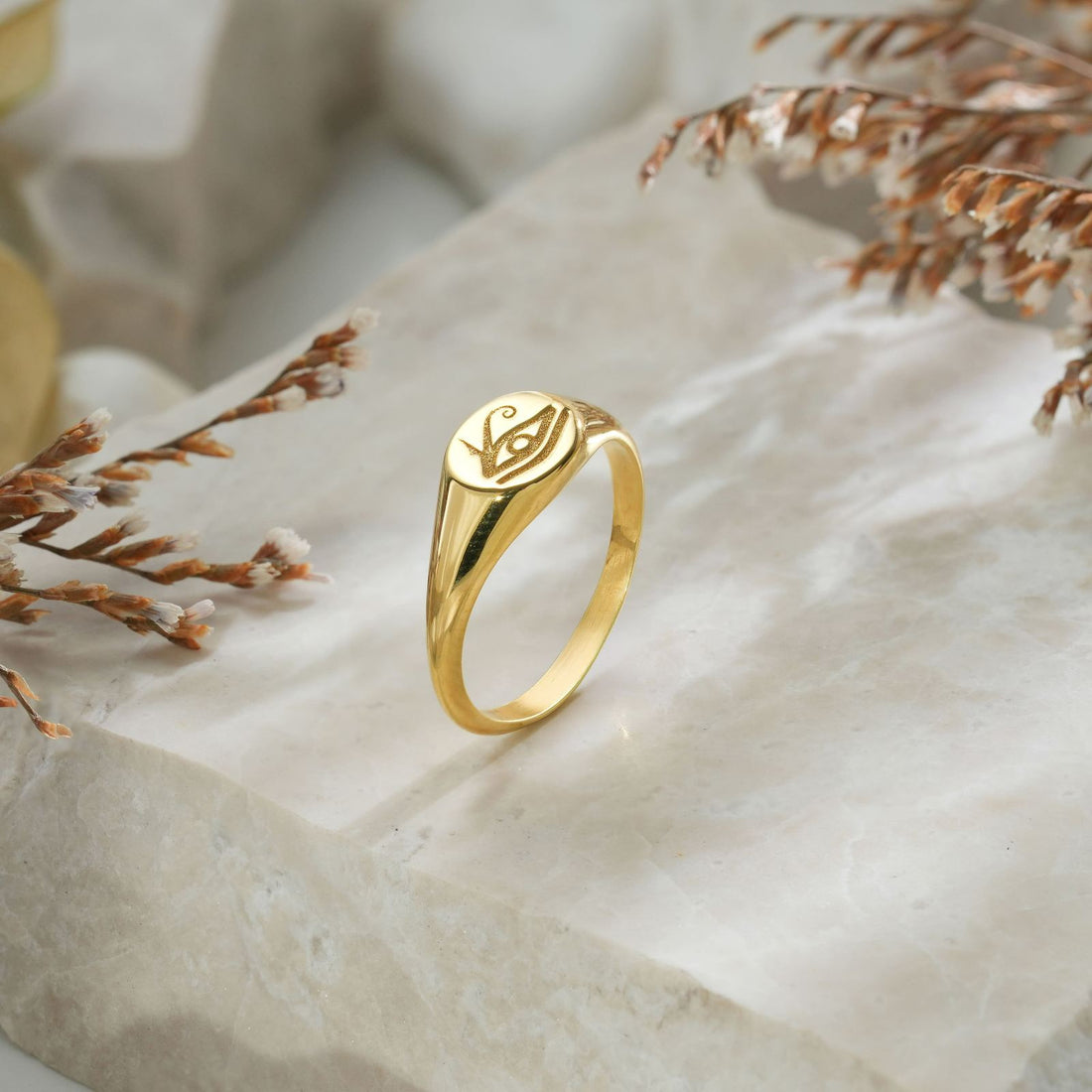 Horus Eye Signet Ring worn on a hand, showcasing its gold vermeil finish and unique design.