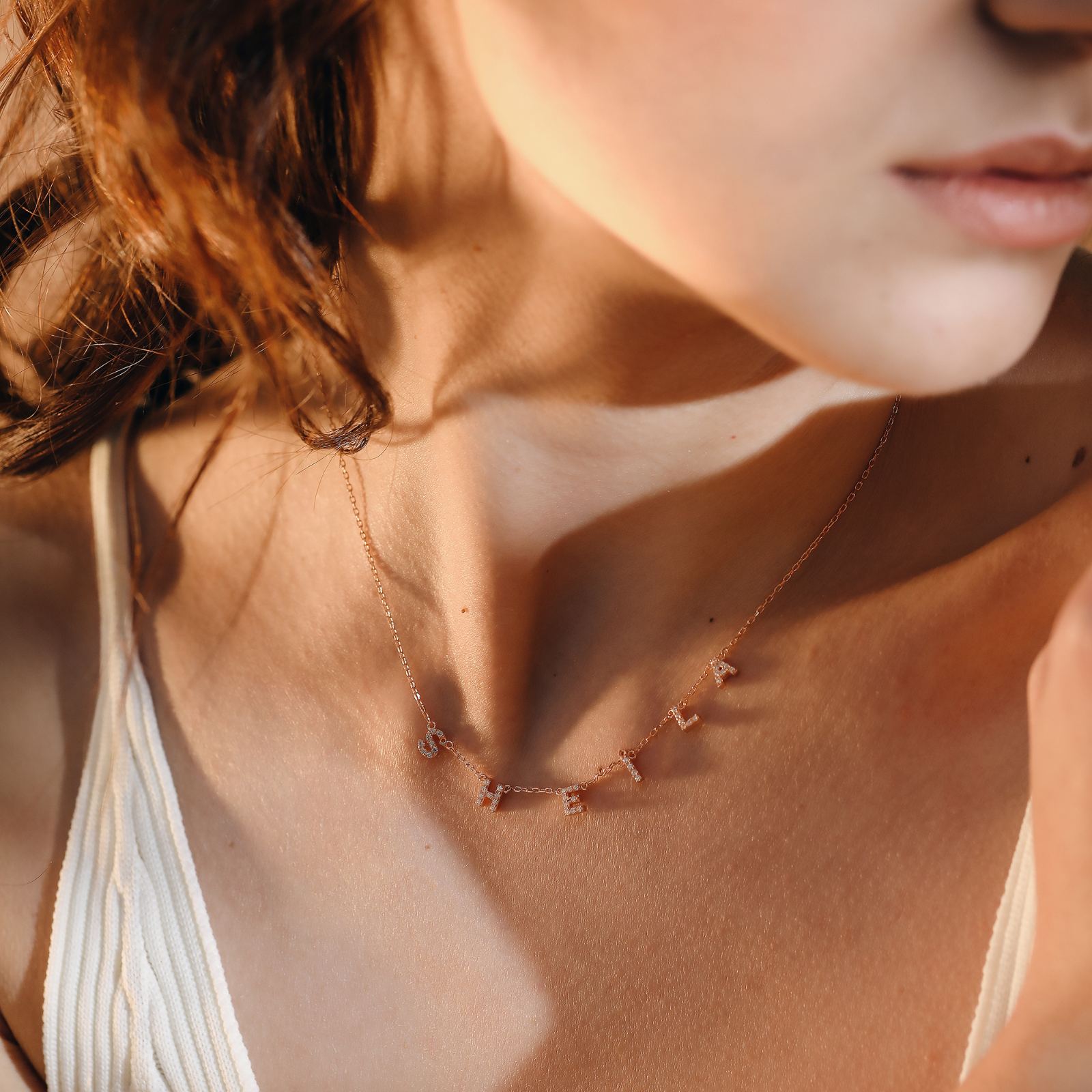 Personalized Tiny Initial Necklace showcased on a woman, featuring delicate letter charms in rose gold.