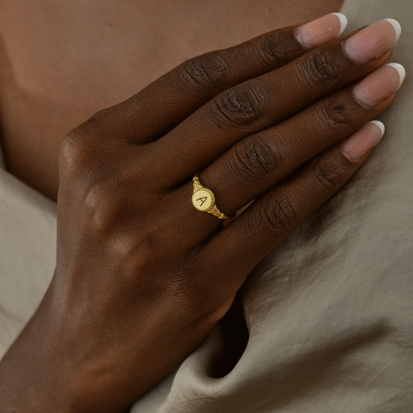 Personalized Initial Signet Letter Ring worn on a hand, featuring a gold vermeil finish and an engraved initial 'A'.