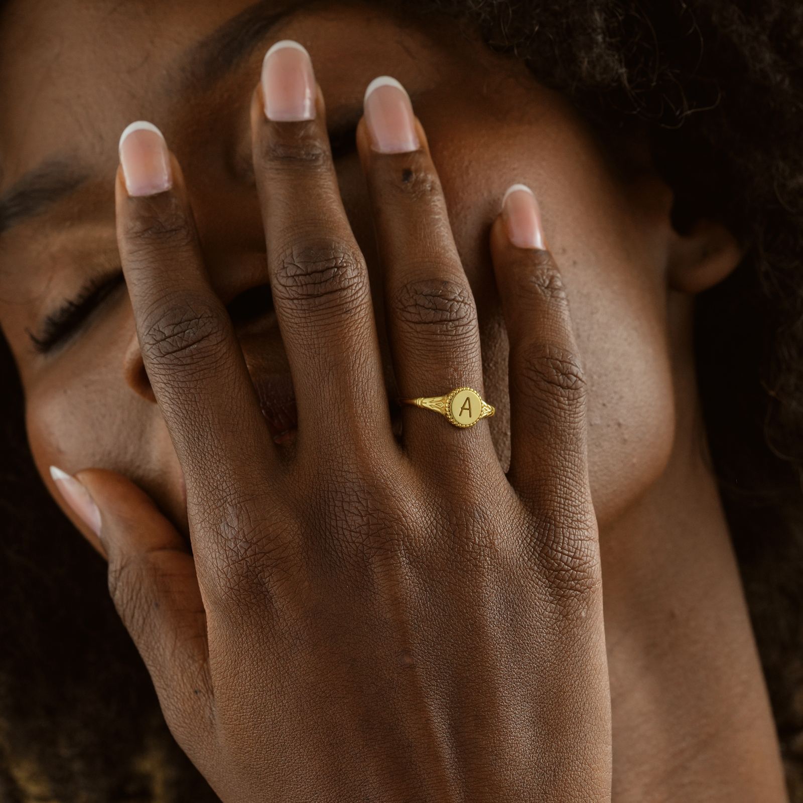 Woman wearing a Personalized Initial Signet Letter Ring with an 'A' in gold vermeil finish.