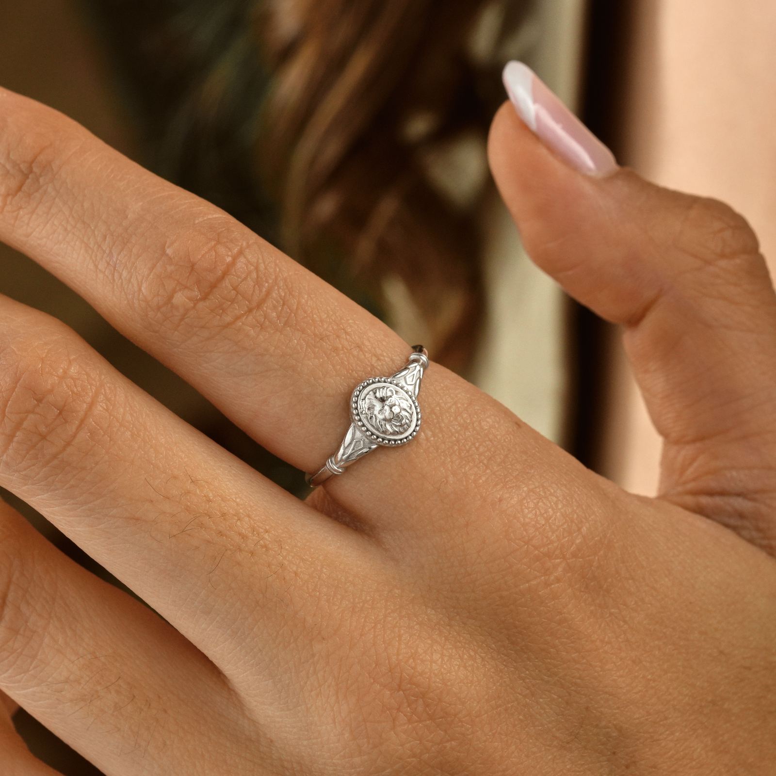 Lion Ring on a hand, showcasing minimalist design in sterling silver for Leo.